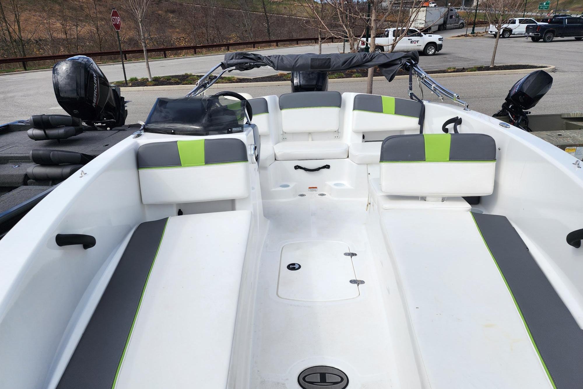 2023 Tahoe T18 boat interior with gray and green seating, parked outdoors.