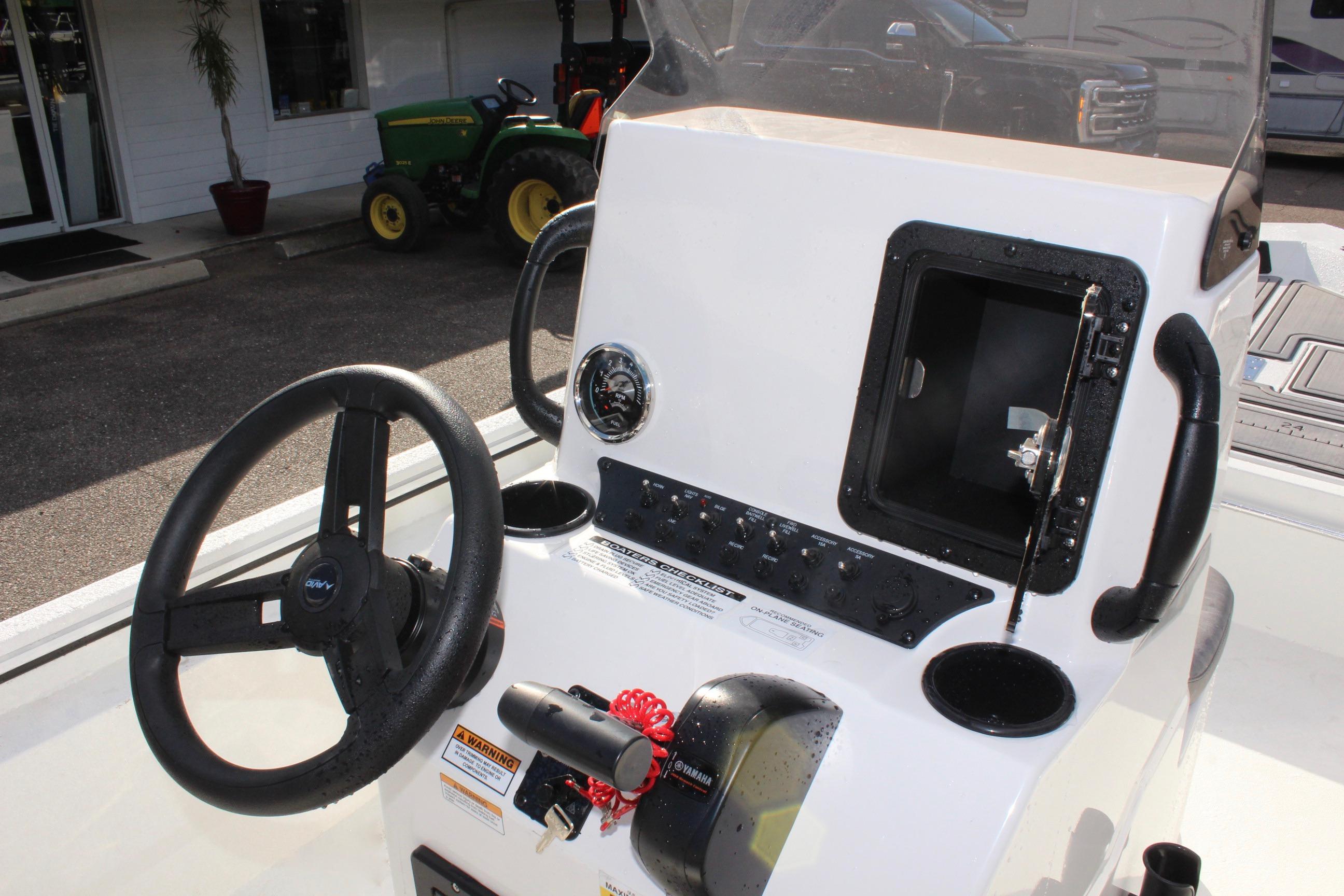 2025 Avid 18 Rogue CC boat console with steering wheel and controls.