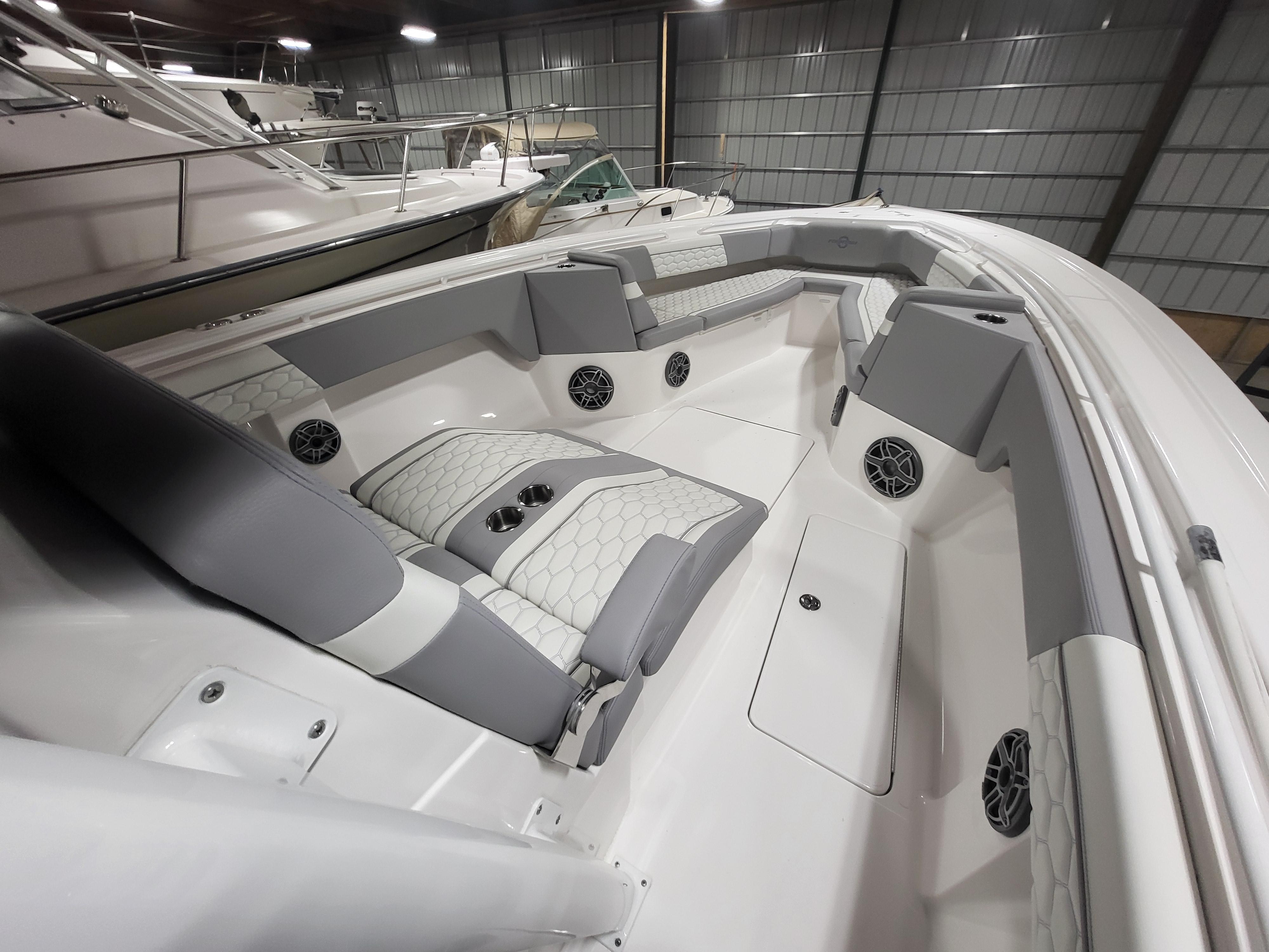 2022 Fountain 38 SC boat interior with gray and white seating in a storage facility.