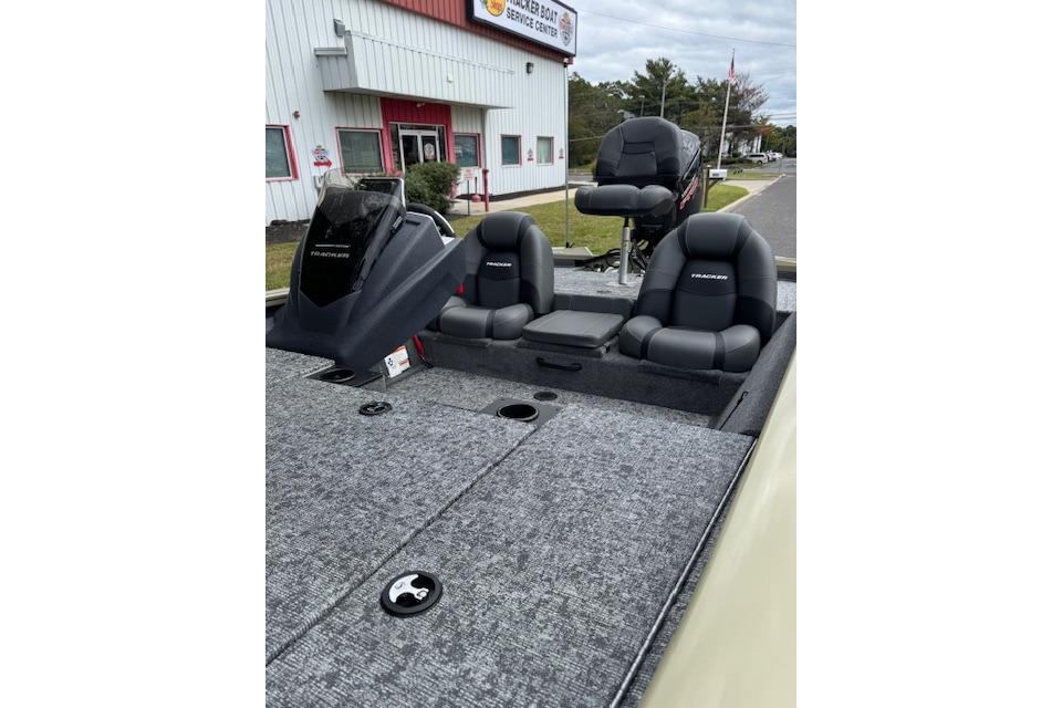 2026 Tracker Pro Team 190 boat with seating, parked outside service center.