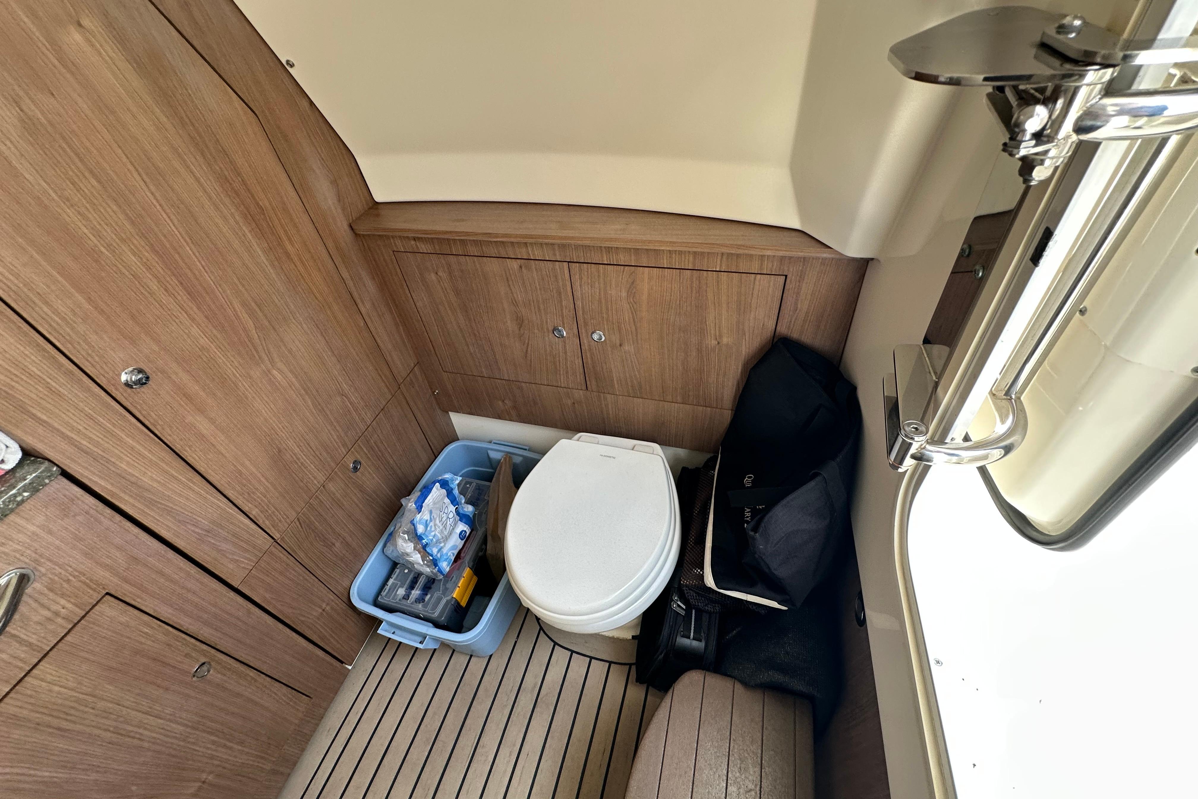 2018 Boston Whaler 350 Outrage cabin interior with toilet and storage area.