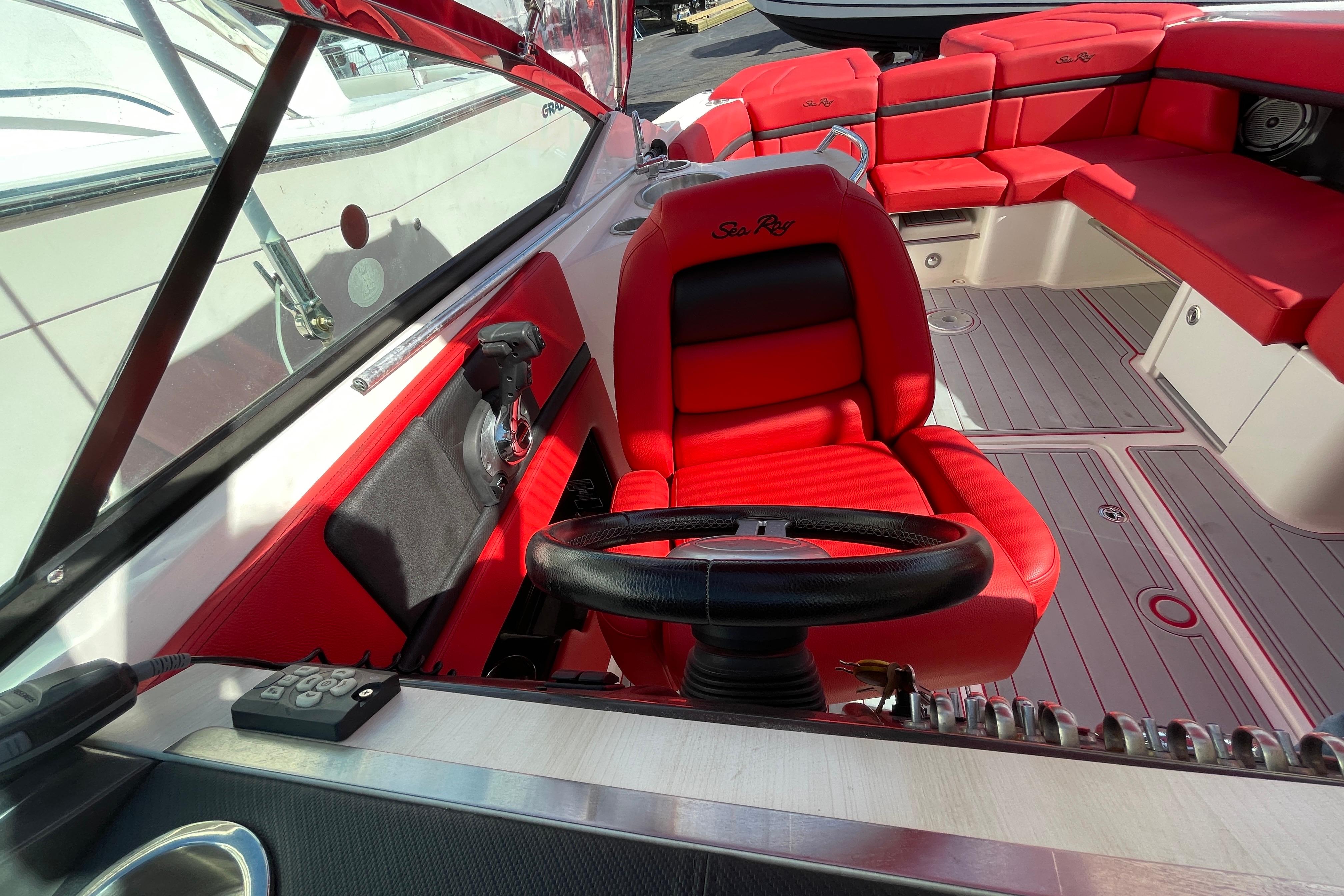 2014 Sea Ray 270 SLX boat interior with red seating and steering wheel.