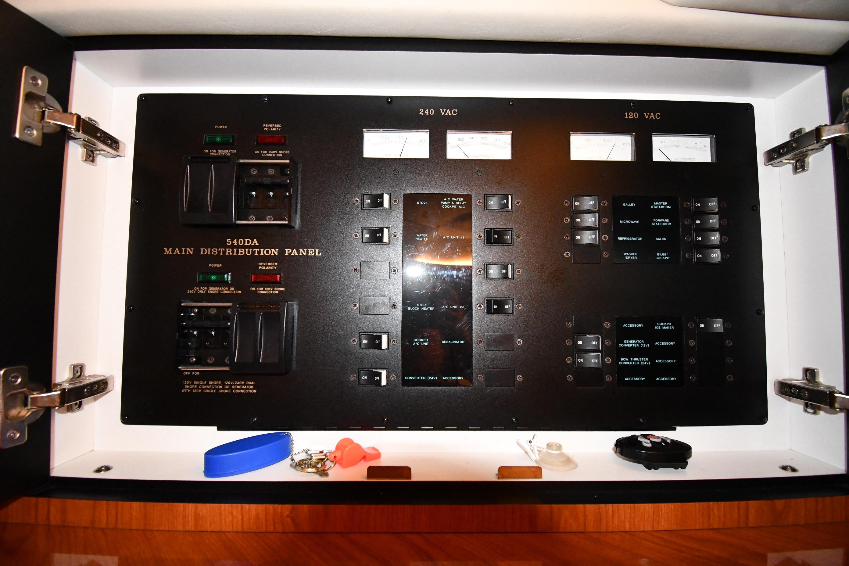 Main distribution panel of 2001 Sea Ray 540 Sundancer yacht, featuring various switches and meters.