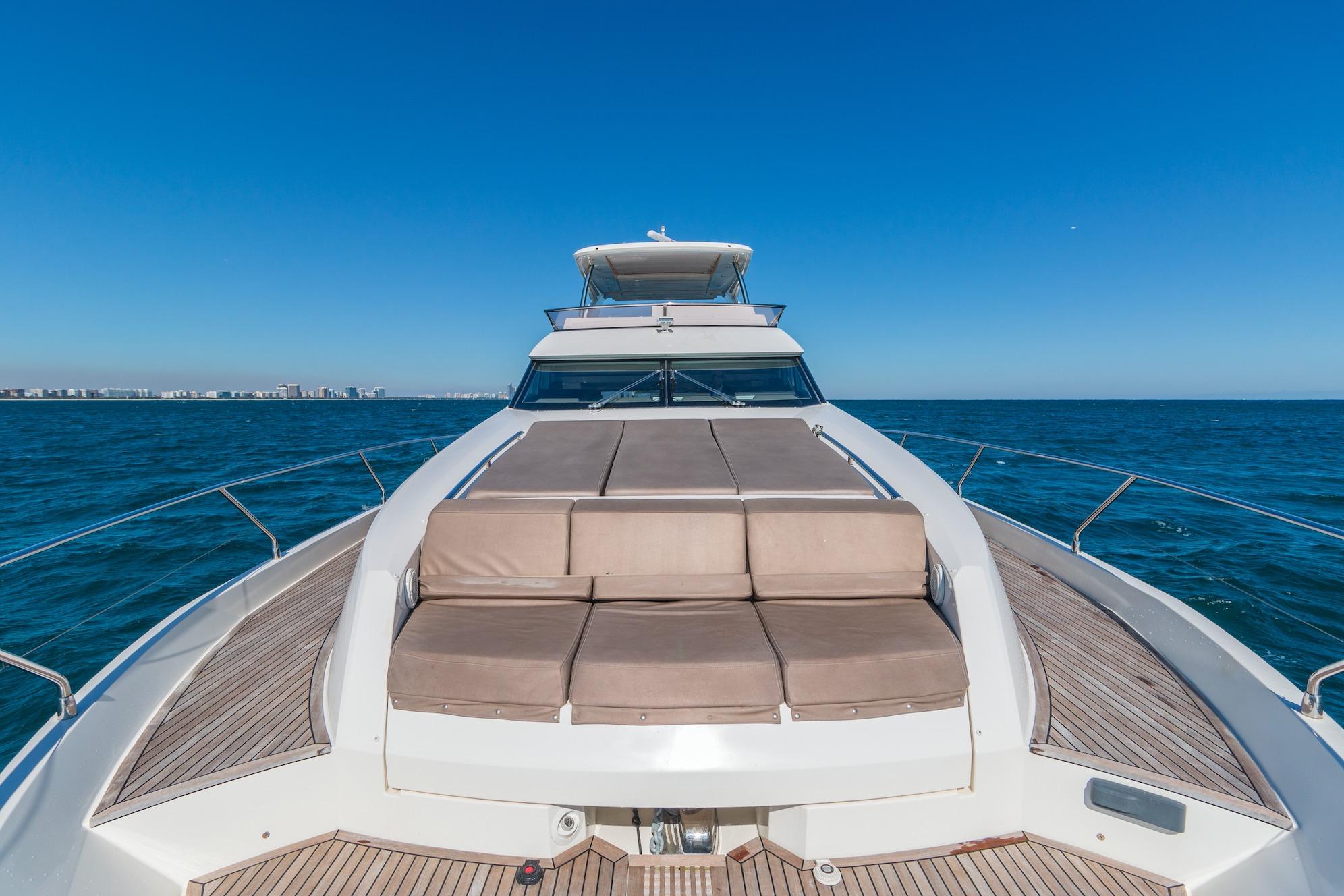 Luxury 2015 Prestige 750 yacht on open sea under clear blue sky.