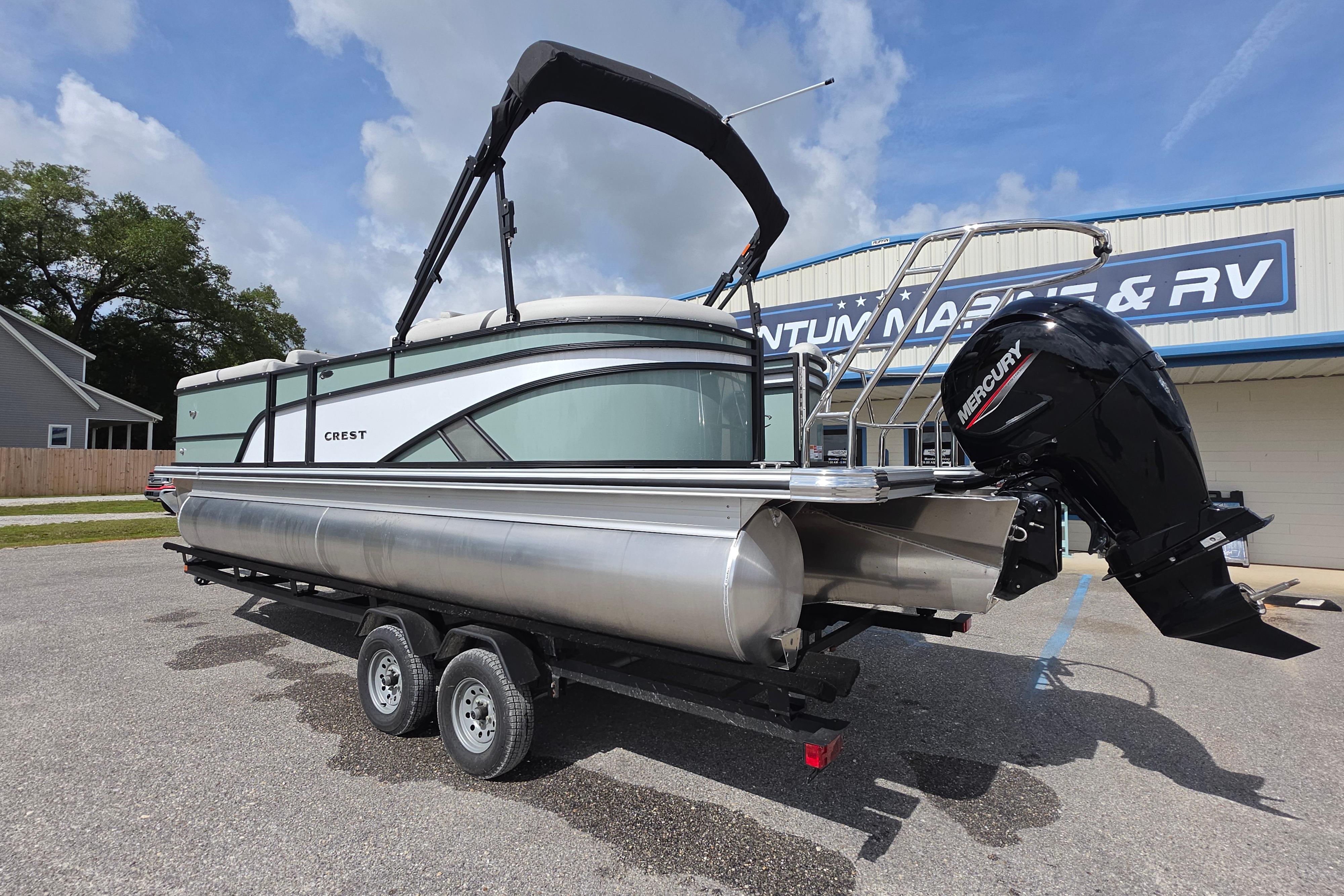 2026 Crest 235 Conquest SLC pontoon boat with Mercury outboard motor on trailer.