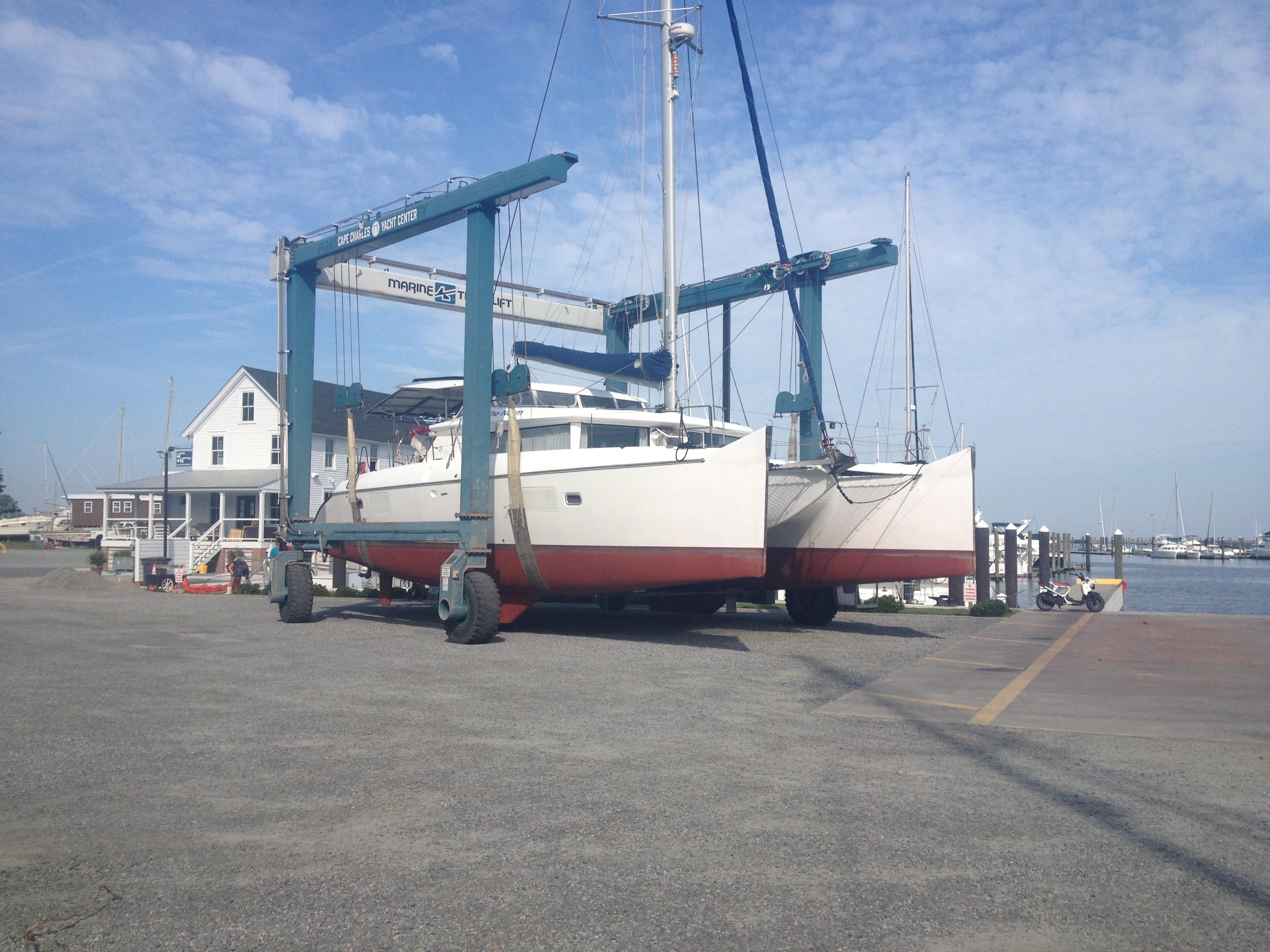 2007 Lagoon 420 catamaran on a boat lift at the harbor.