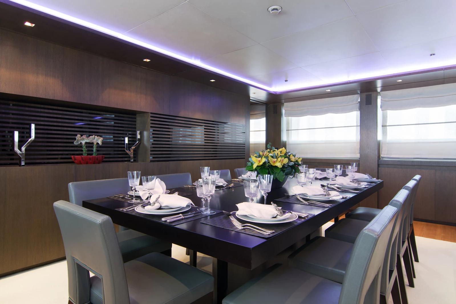 Luxurious yacht dining room with elegant table setting, modern decor, and ambient lighting, Admiral 2009.