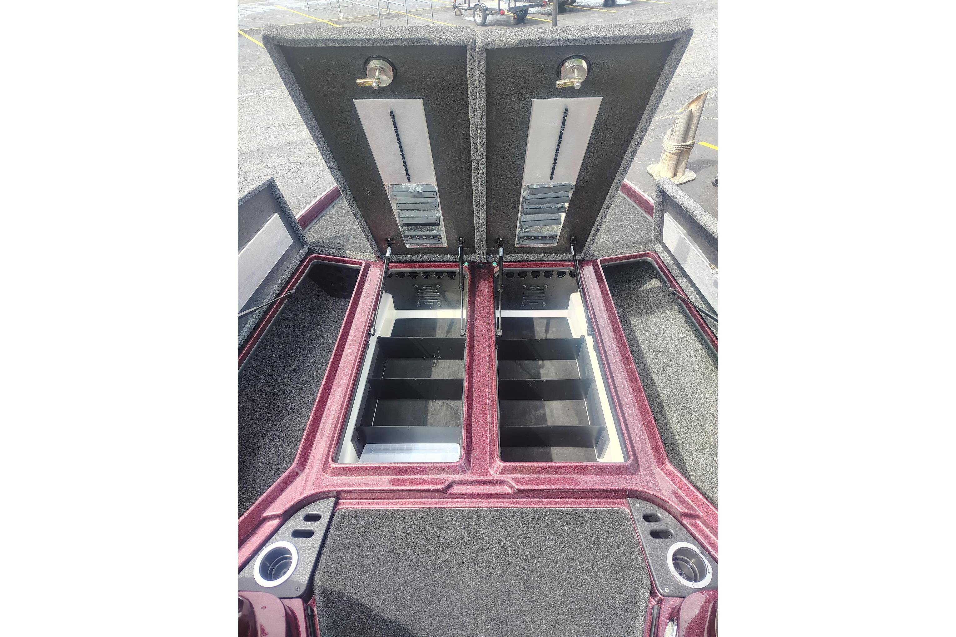 2024 Nitro Z21 XL boat storage compartments with open lids, showcasing organized interior space.