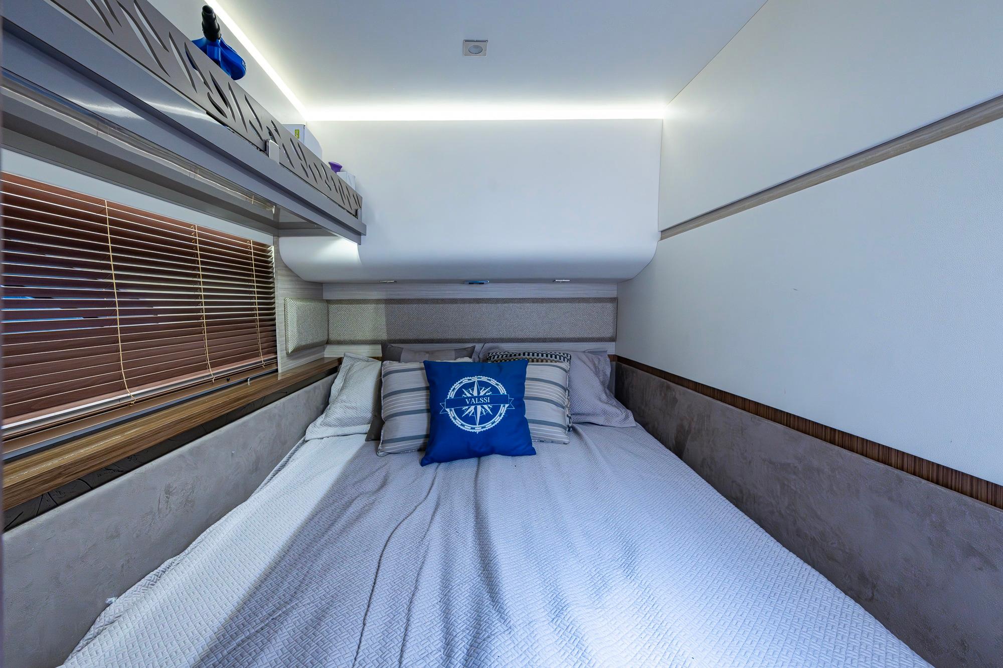 Luxurious bedroom interior of 2018 Sea Ray L550 Fly yacht with nautical-themed decor.