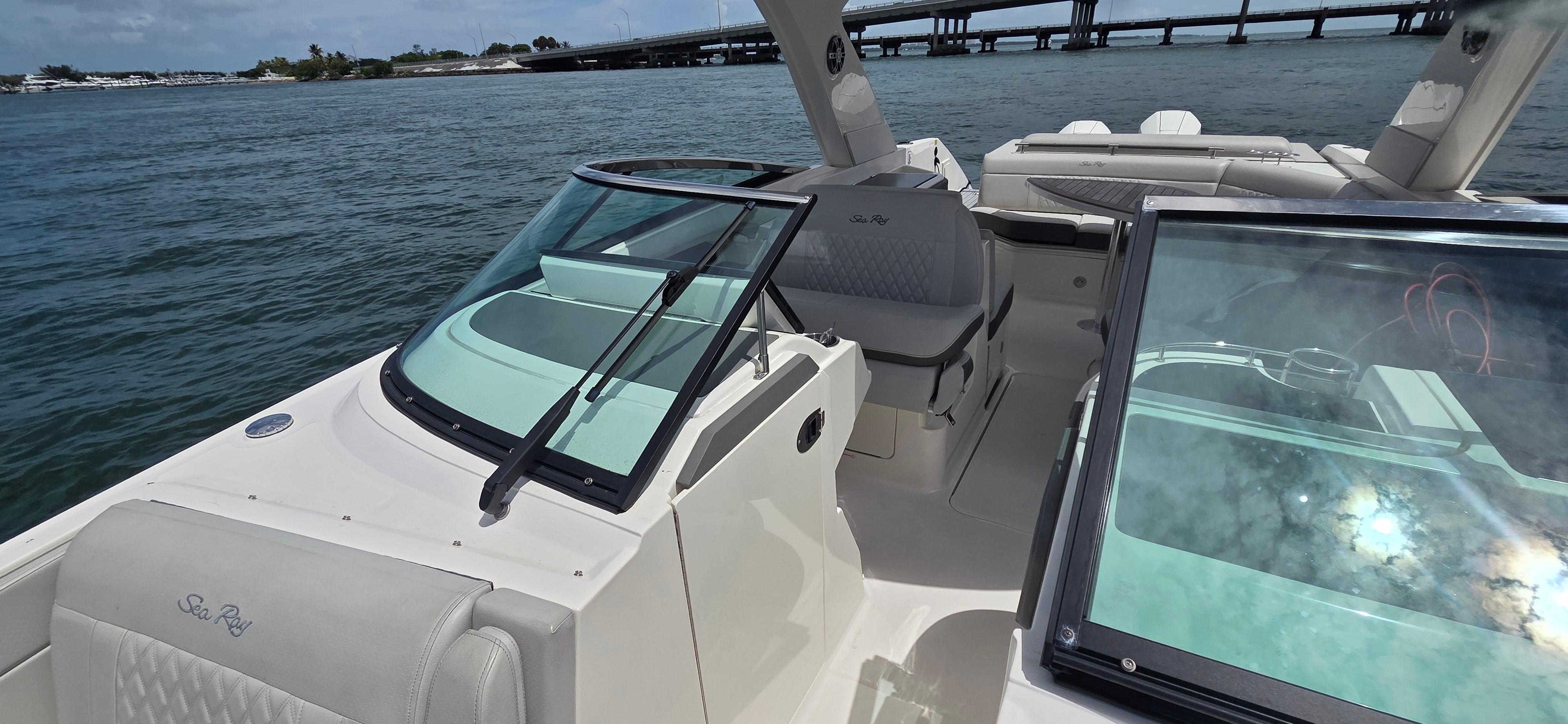 2021 Sea Ray SLX 310 Outboard boat on water, featuring spacious seating and sleek design.