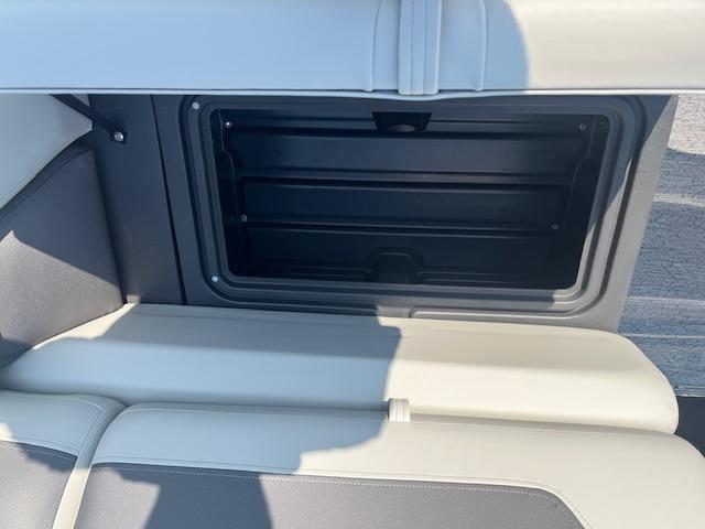 2026 Sun Tracker Fishin' Barge 20 DLX storage compartment with open lid.