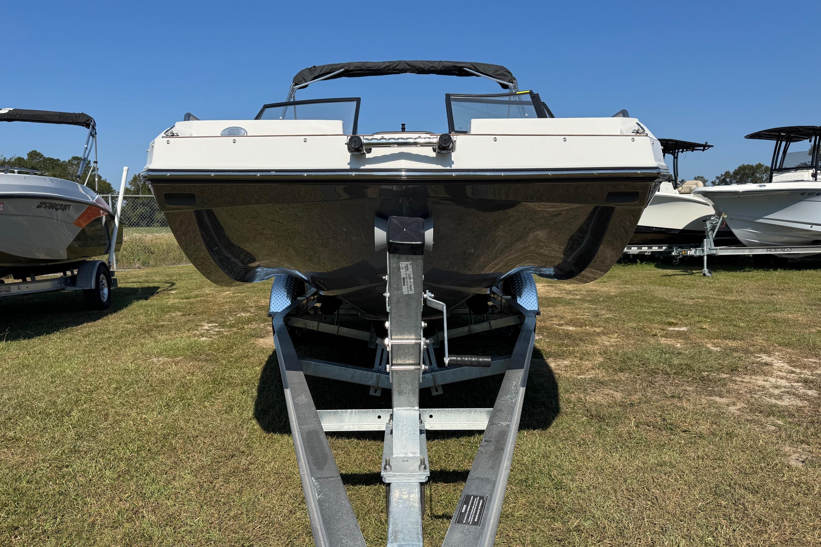 2026 Starcraft SVX 190 OB boat on trailer, displayed outdoors under clear blue sky.