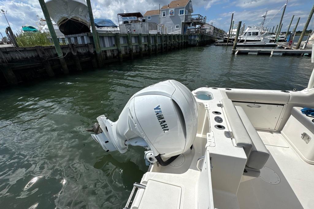 2025 Sailfish 245 DC boat with Yamaha outboard motor docked at marina.
