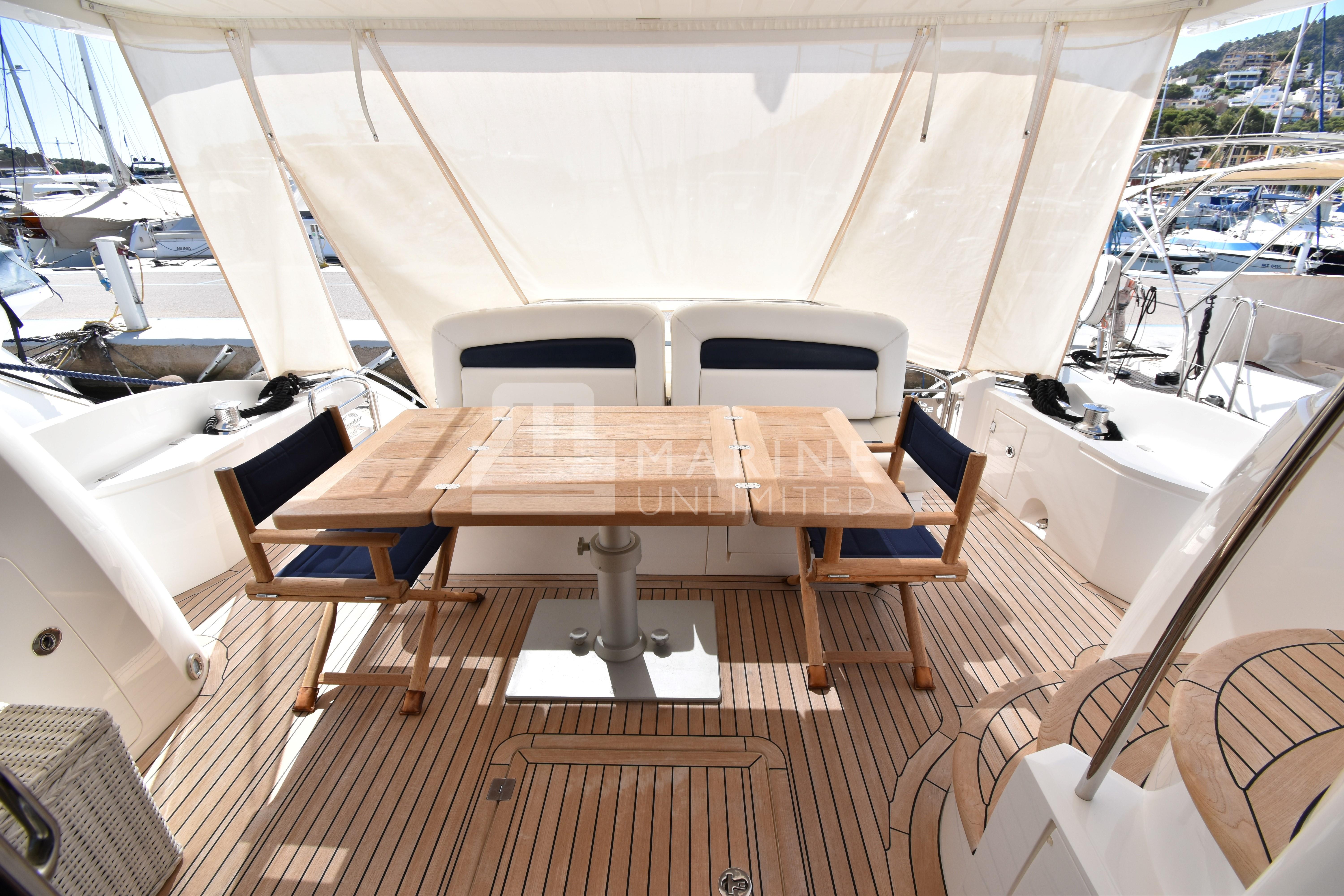 Sunseeker Manhattan 52 yacht deck with wooden table and chairs, 2010 model.
