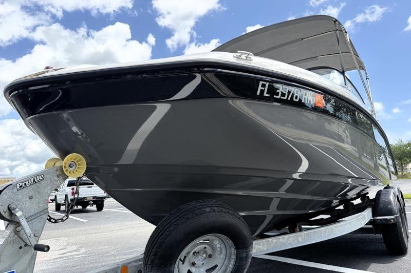 2017 Yamaha Boats SX210 on trailer under blue sky, showcasing sleek design.