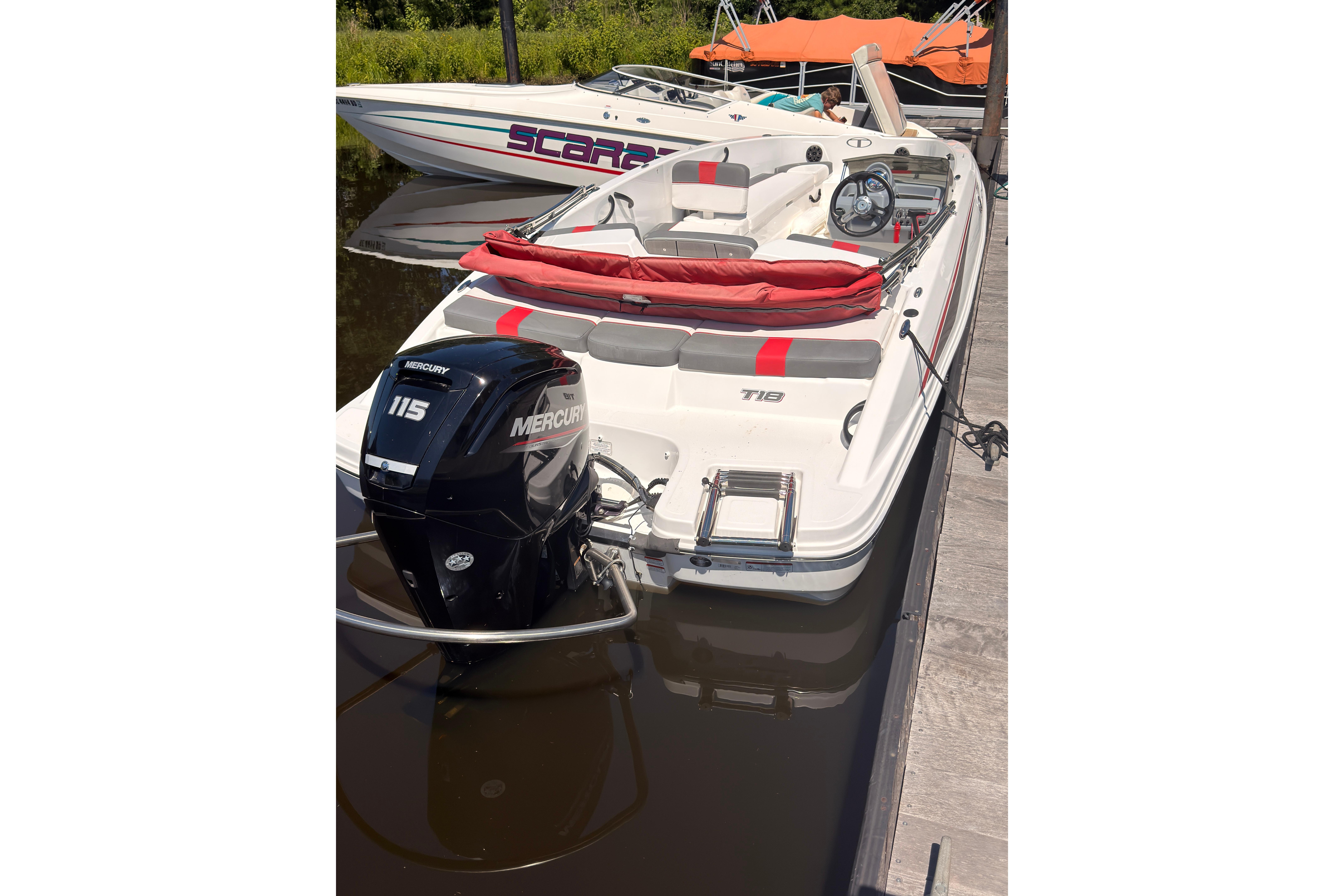 2022 Tahoe T18 boat docked with Mercury 115 outboard motor.