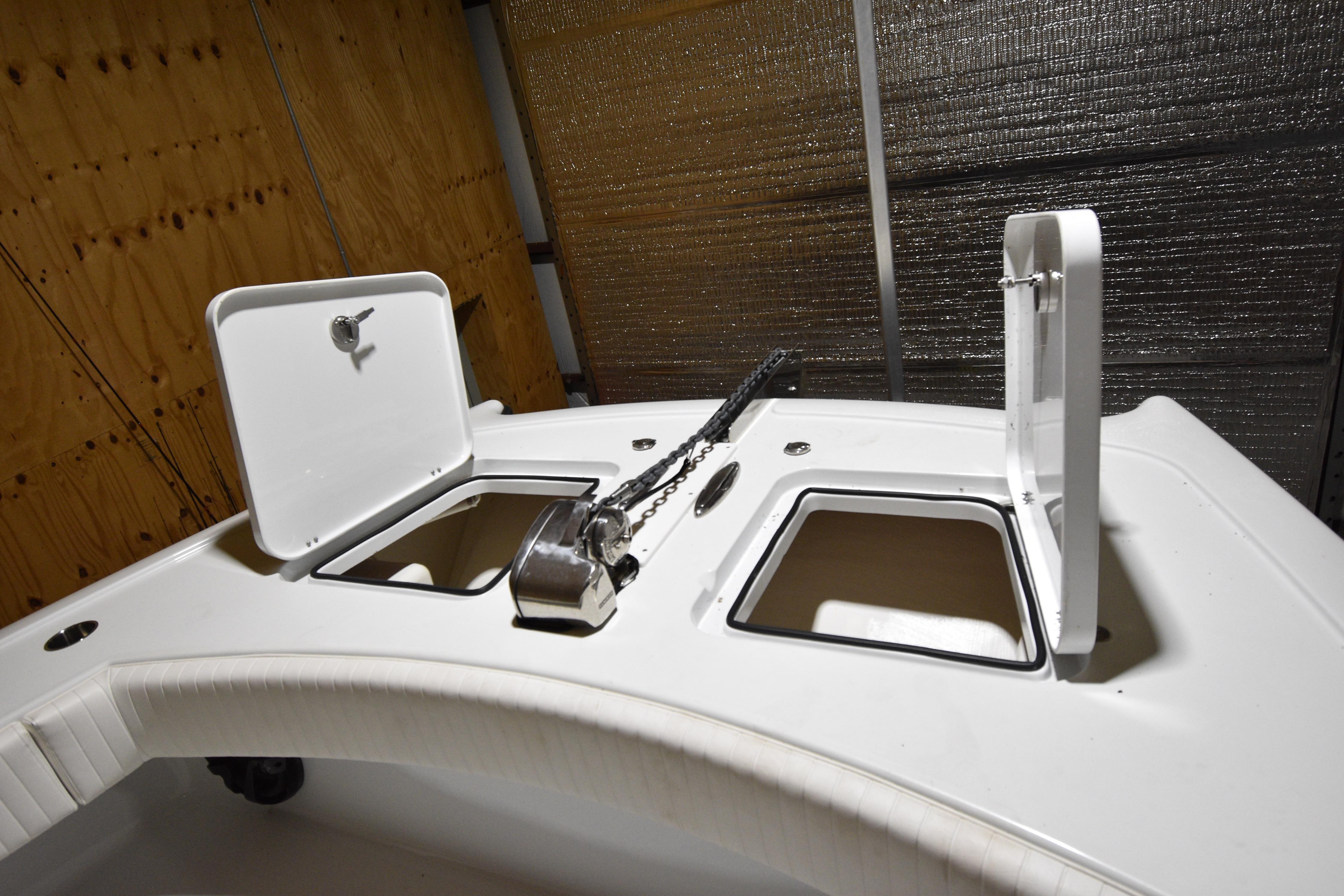Open storage compartments on a 2016 Freeman 37VH boat deck.