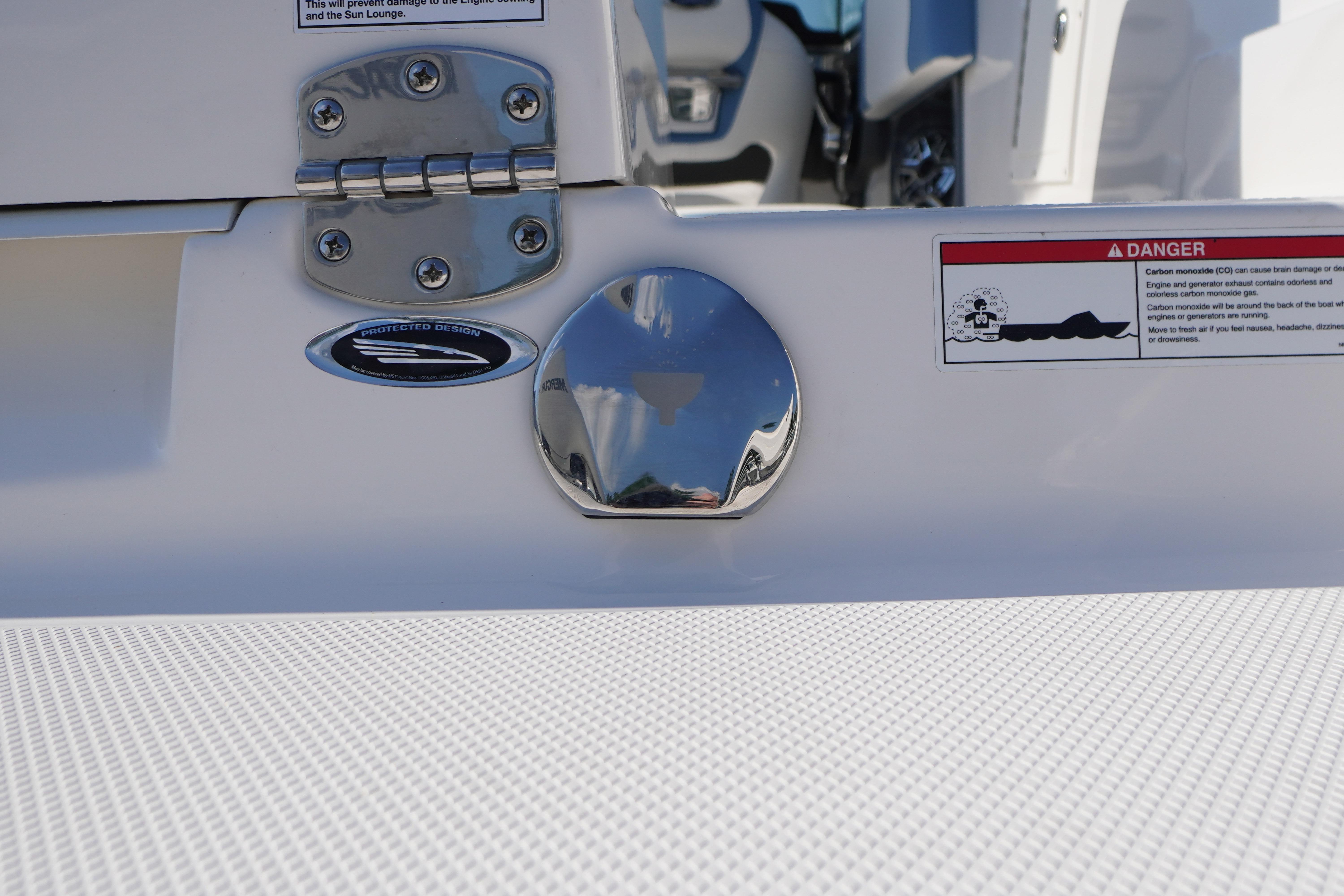 2026 Chaparral 270 OSX boat detail with chrome fittings and safety warning label.