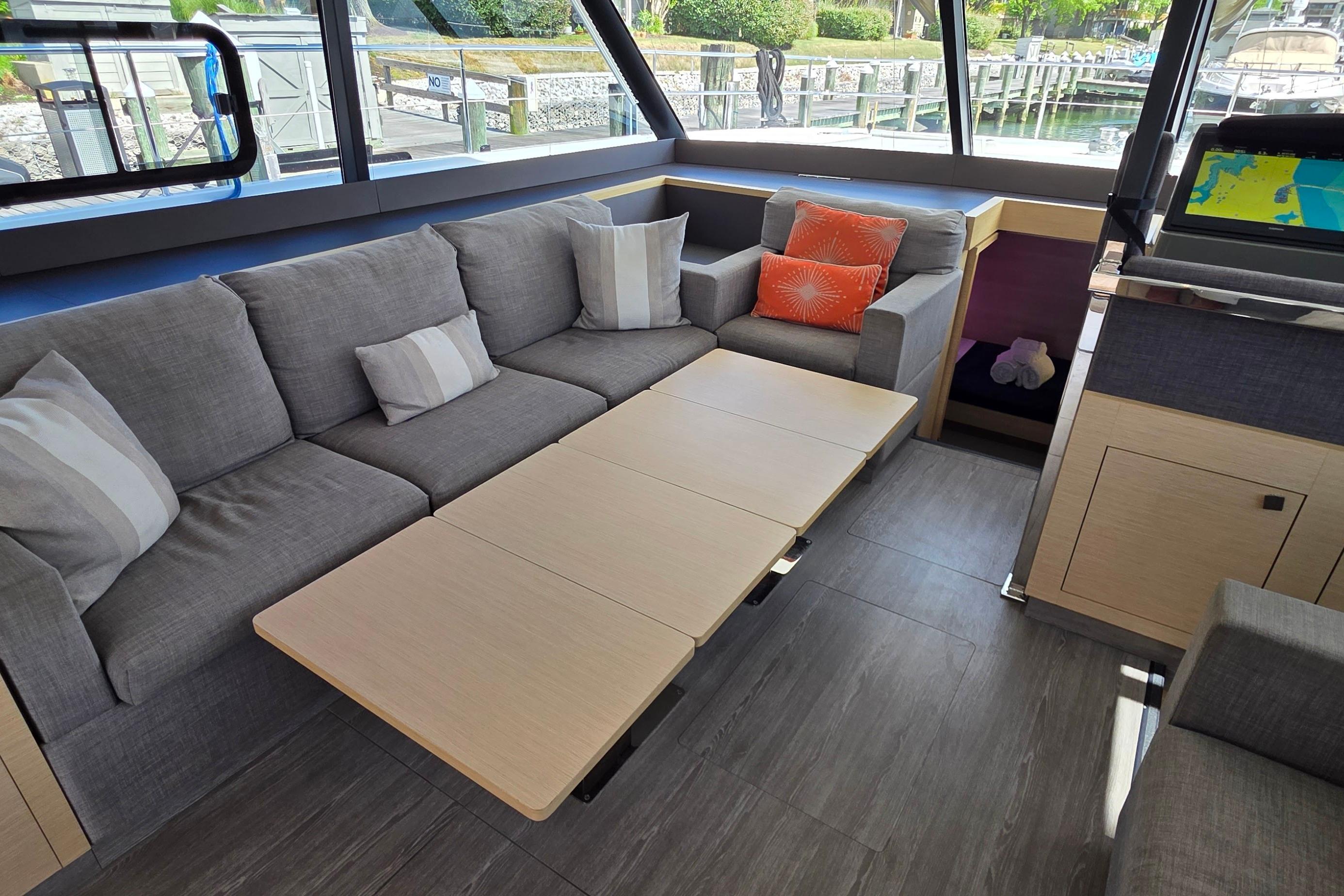 Luxurious interior of 2018 Fountaine Pajot Motor Yacht 44 with modern seating and navigation equipment.