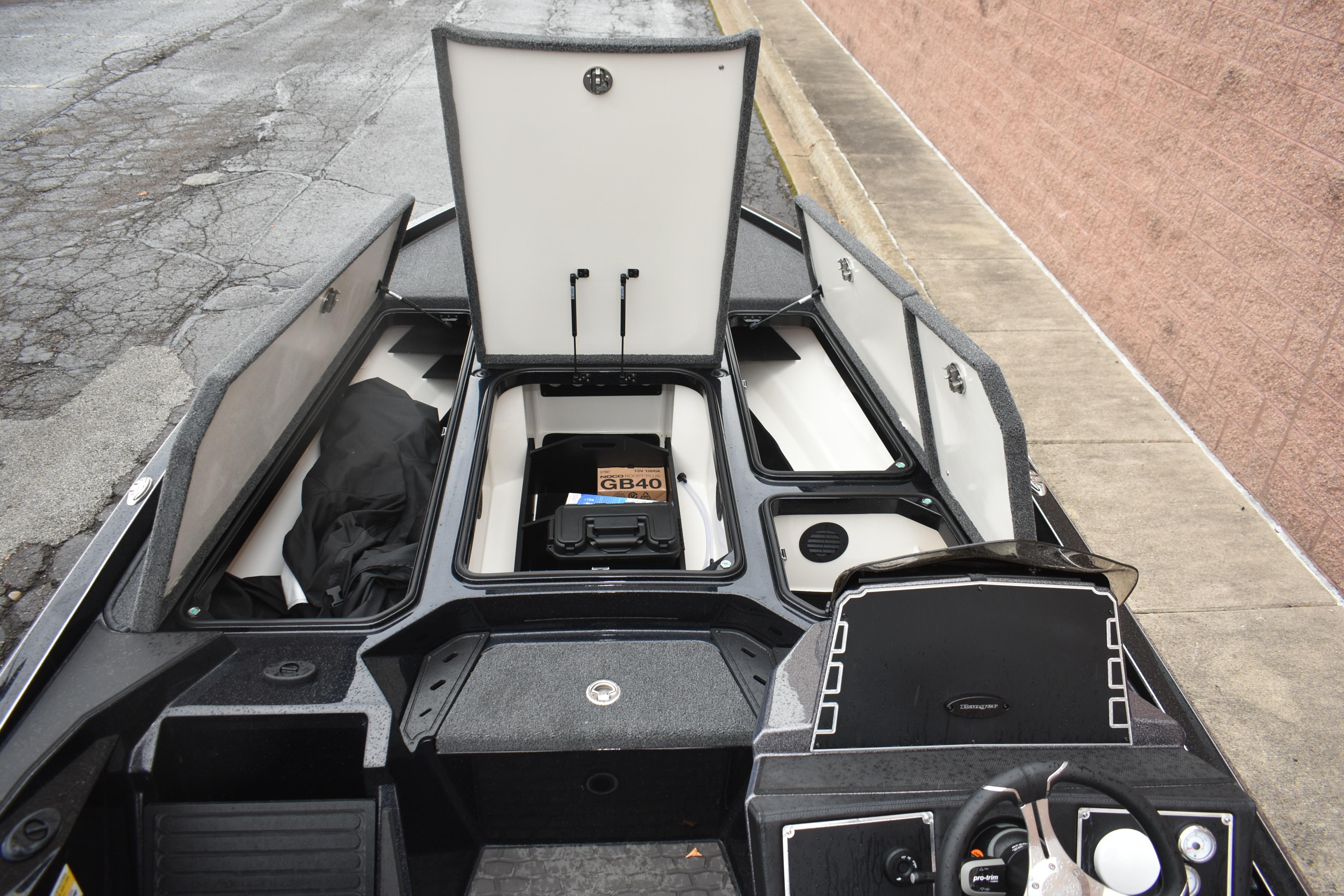 2025 Ranger Z521 boat interior with open storage compartments and control panel.