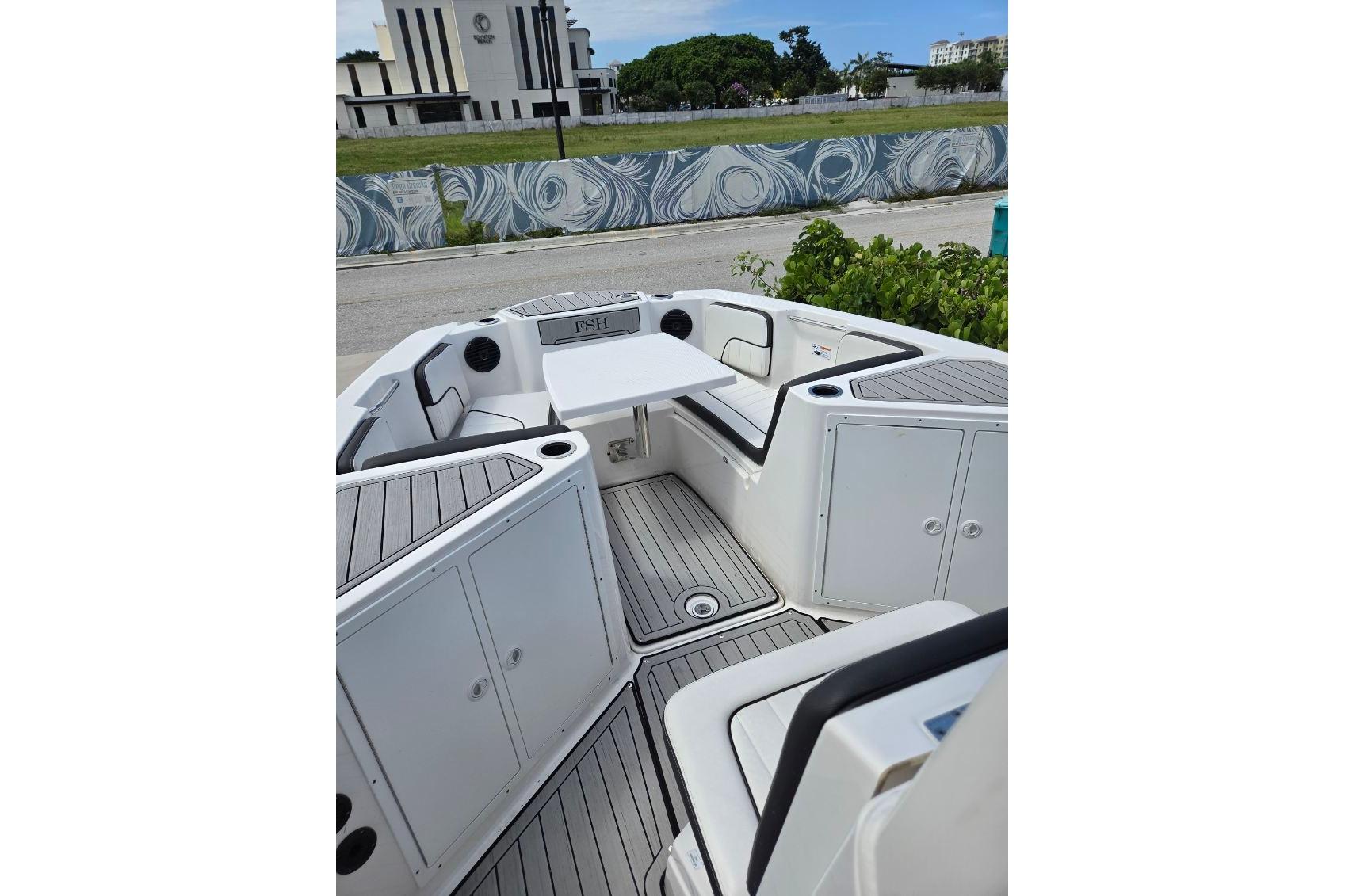 2024 Yamaha Boats 222 FSH Sport E interior with seating and storage compartments.