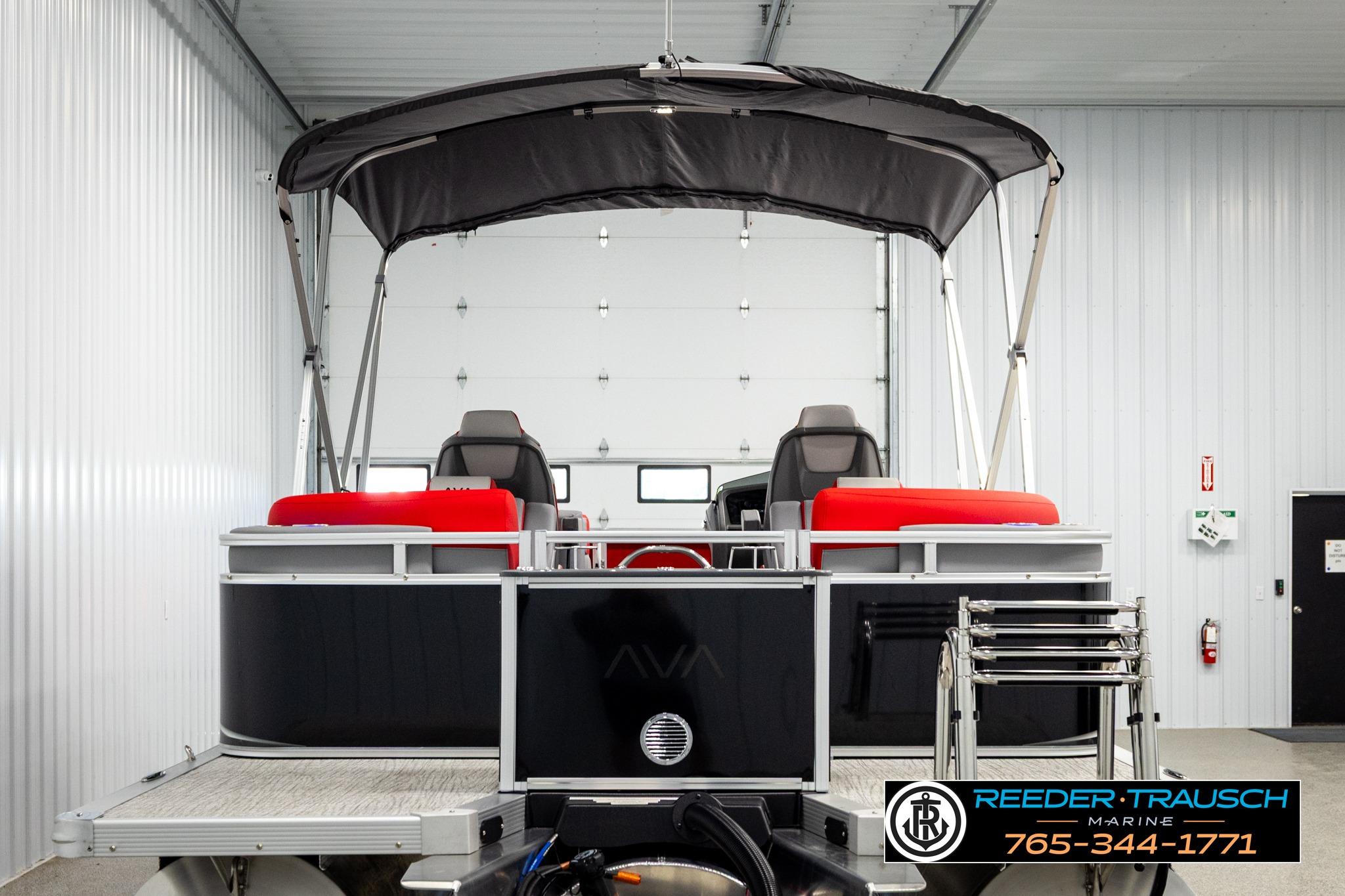 2026 Avalon LSZ QL pontoon boat with canopy in a showroom.