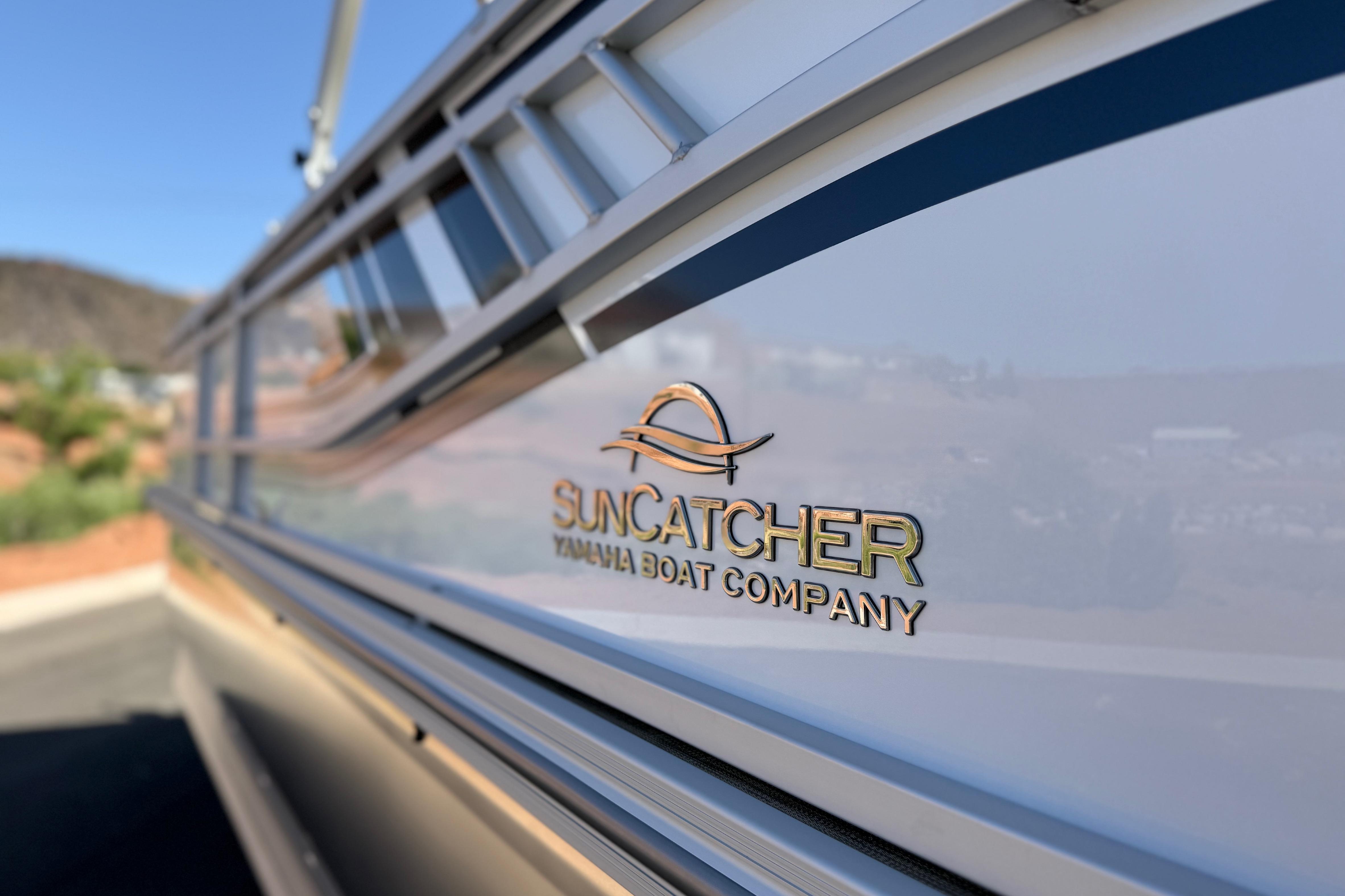 2026 SunCatcher Select 322SL boat with logo, showcasing sleek design and branding.
