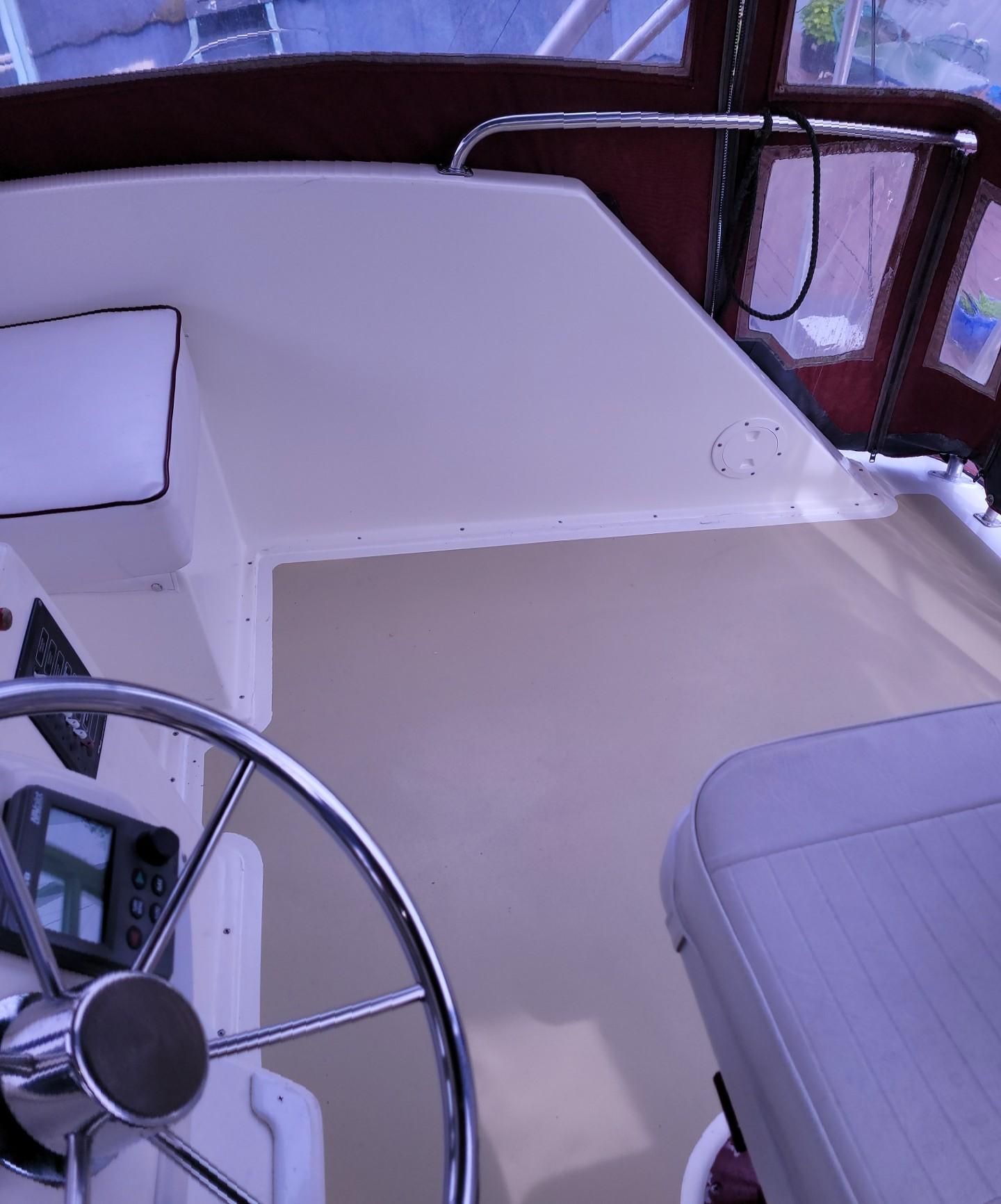 1983 Ocean Yachts Super Sport boat helm with steering wheel and navigation equipment.