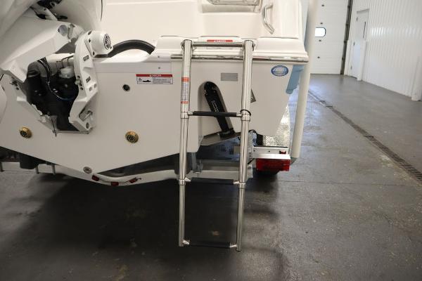 2025 Sea Fox 228 Traveler boat with rear ladder in a garage setting.