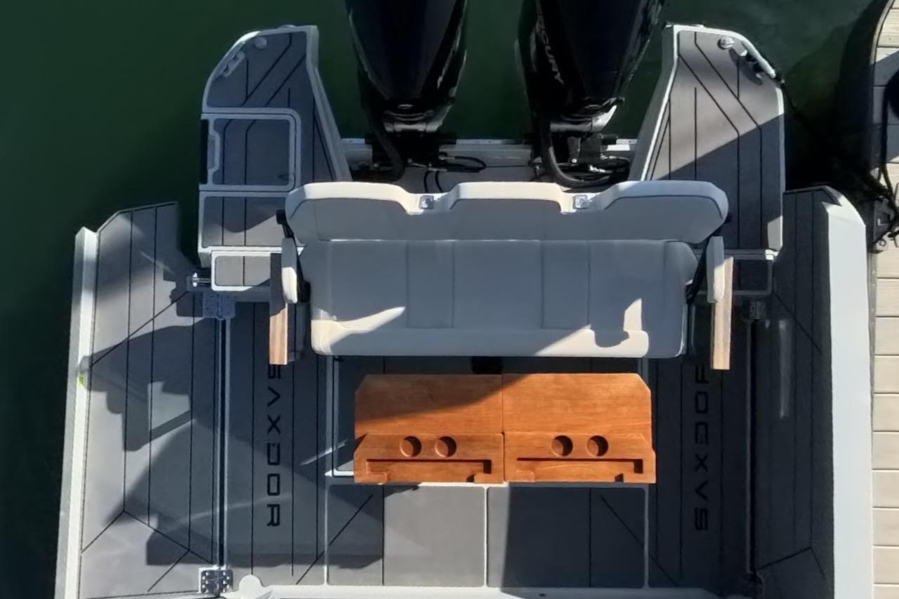 2024 Saxdor 320 GTC boat deck with seating and wooden table, viewed from above.