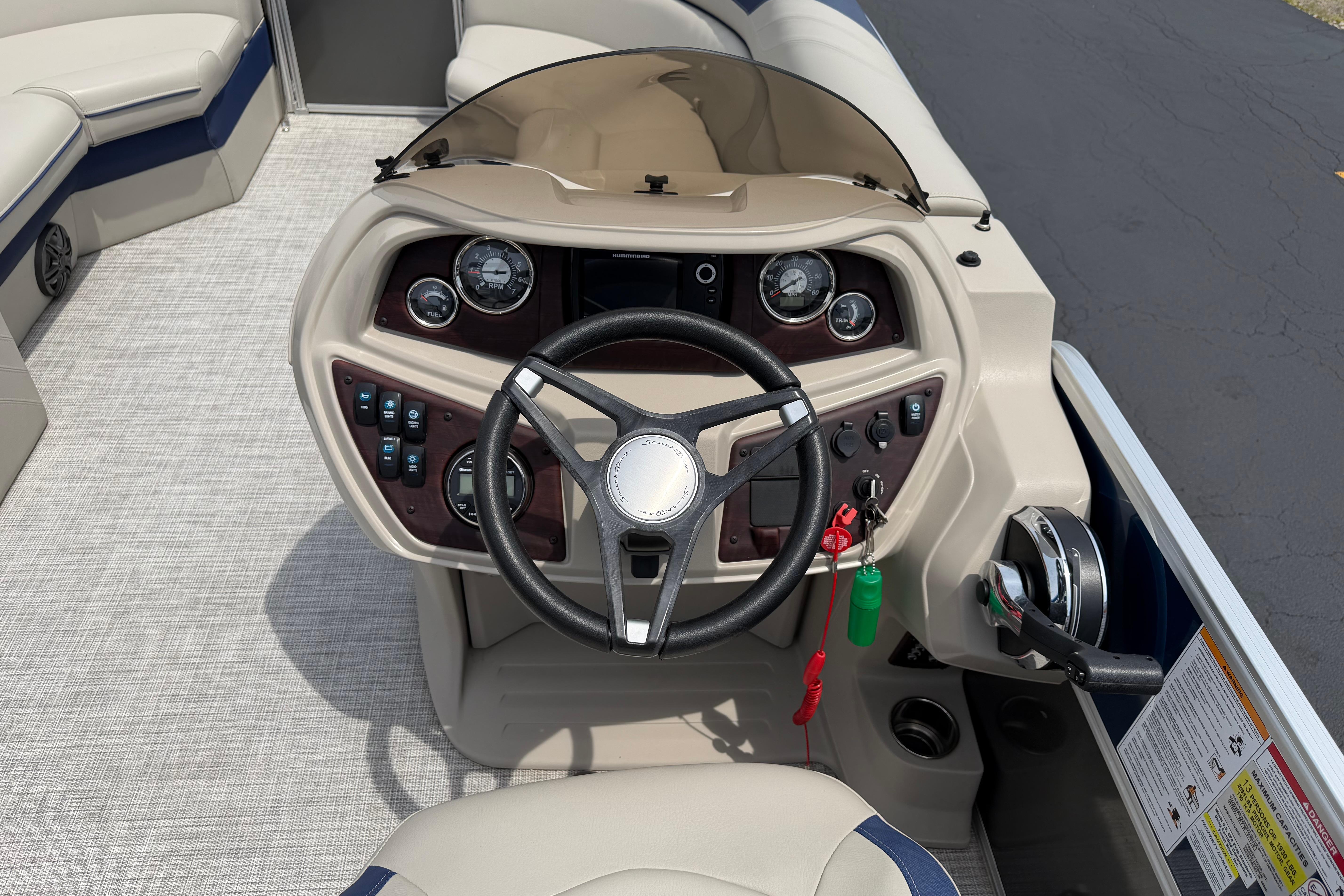 Steering console of a 2021 South Bay 224RS LE pontoon boat with modern controls.