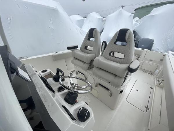 2023 Sailfish 290 CC boat interior with dual captain's chairs and steering console.