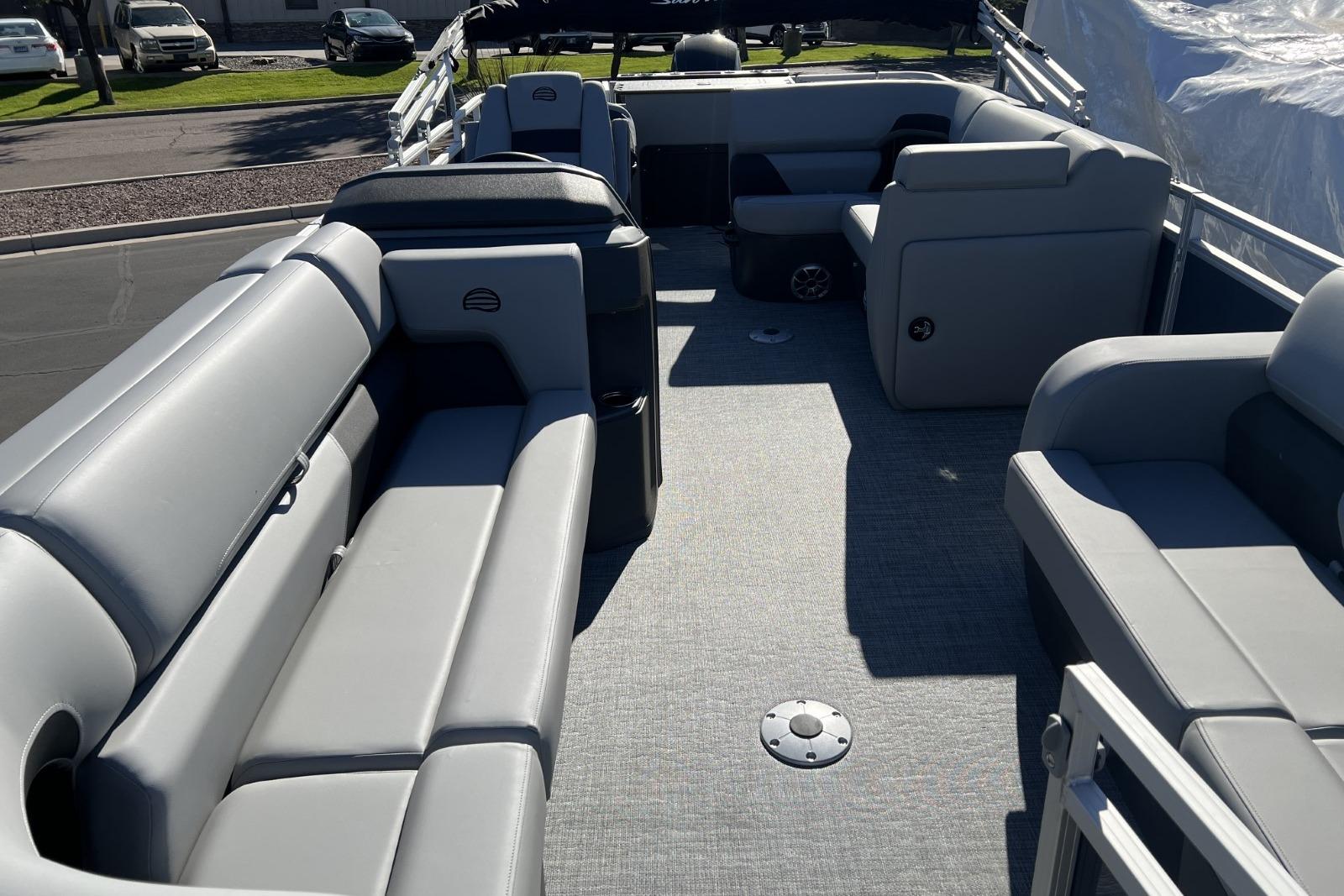 2026 Sun Tracker SportFish 22 DLX pontoon boat interior with gray seating and spacious layout.