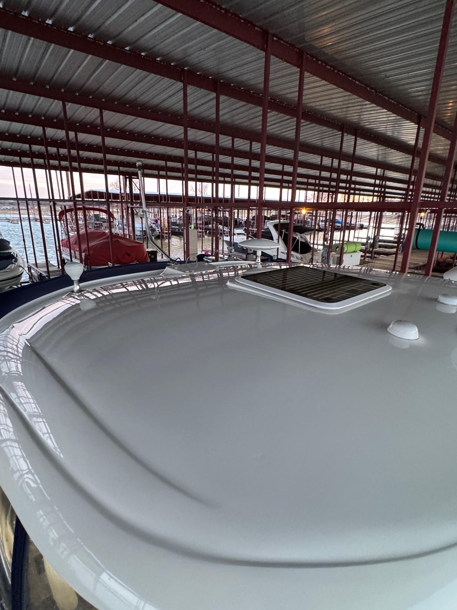 2007 Sea Ray 38 Sundancer yacht docked under metal canopy.