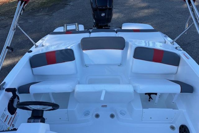 2026 Tahoe T16 boat interior with gray and red seating, steering wheel, and motor.