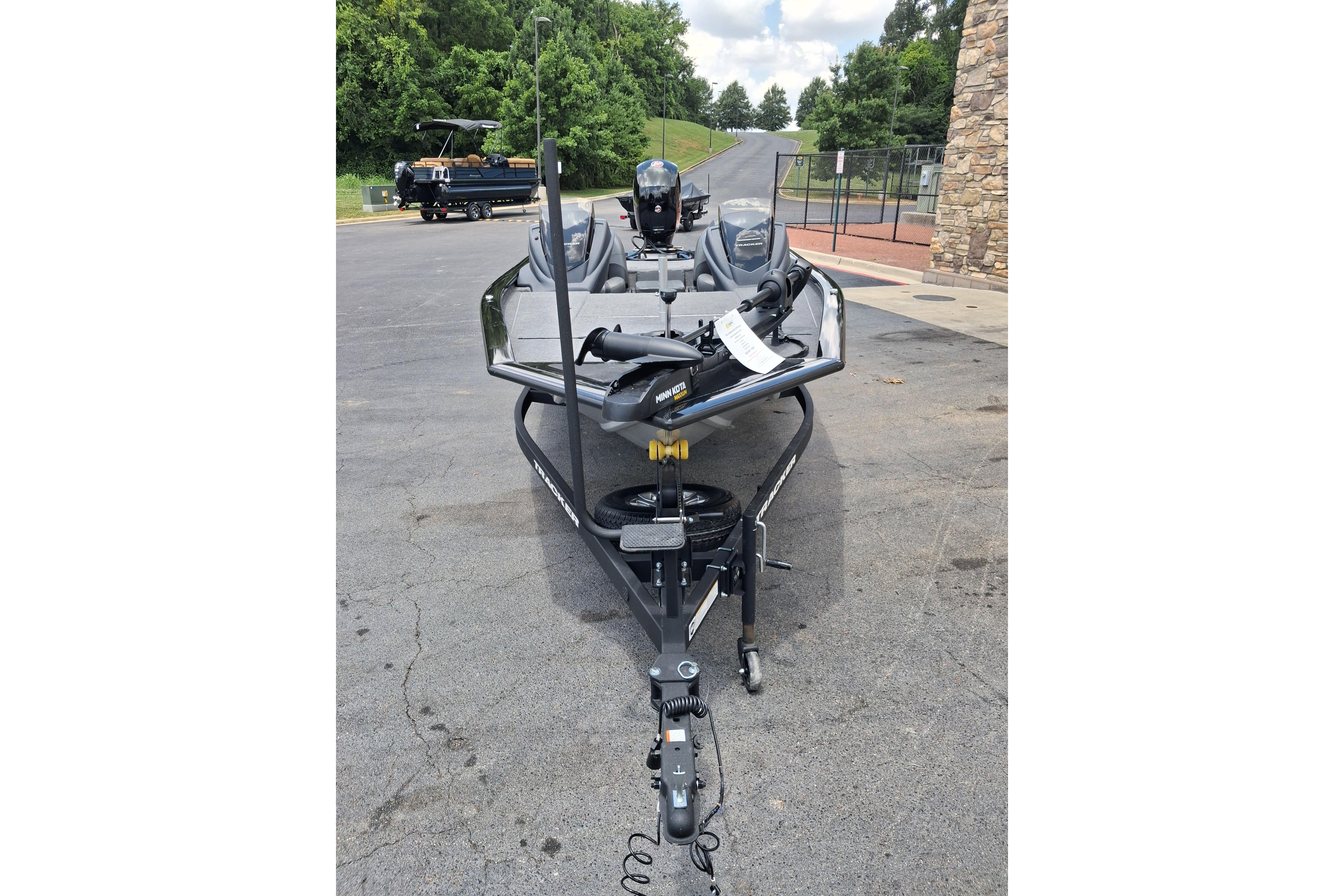 2025 Tracker Pro Team 195 Tournament Edition boat on trailer, parked outdoors.