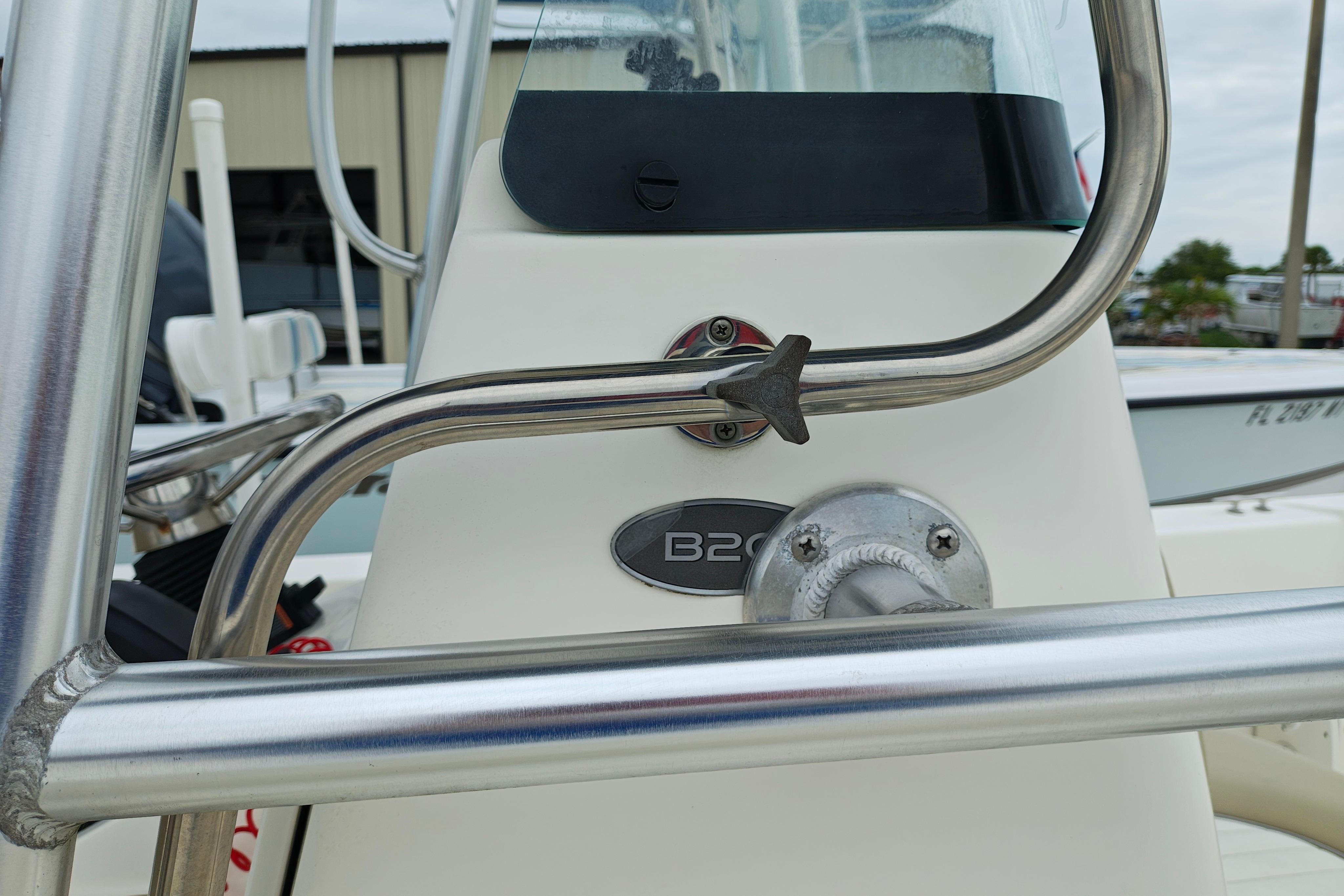 2018 Sundance B20CCR boat console with stainless steel railings and model emblem.