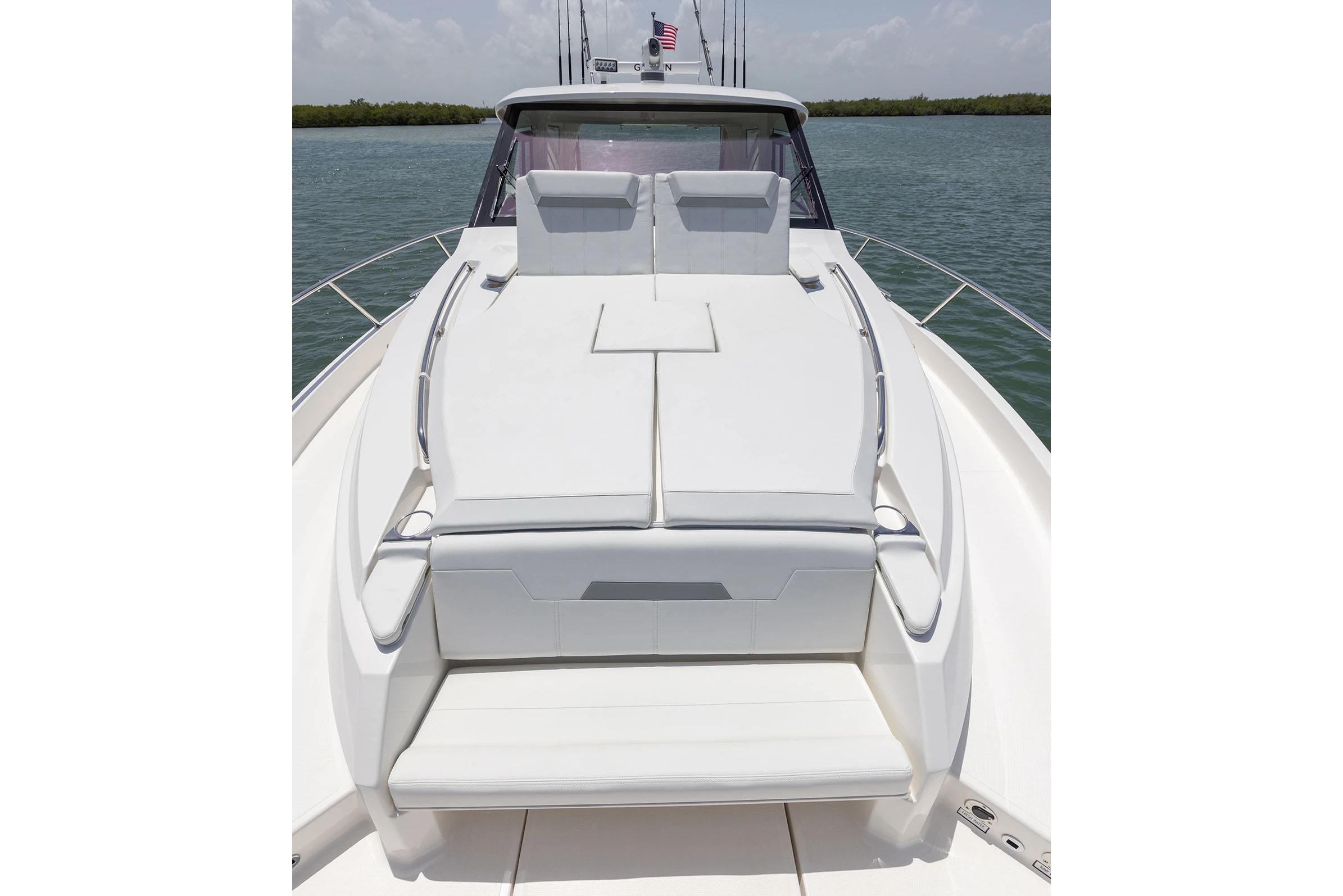 Manufacturer Provided Image: 2025 Pursuit OS 445 Offshore boat with spacious deck and seating, on calm water.