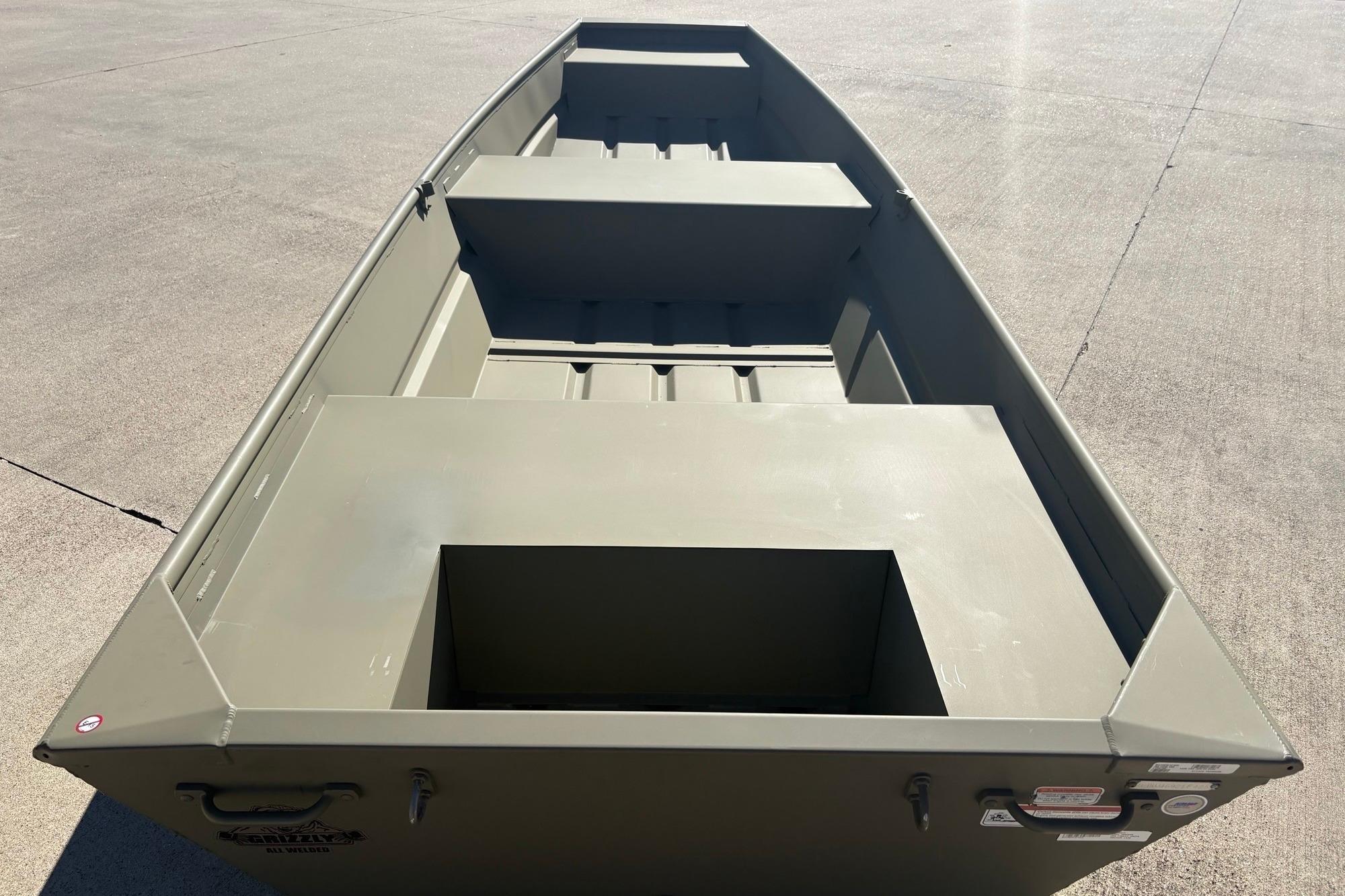 2026 Tracker Grizzly 14 Jon boat on concrete surface, showcasing interior layout.