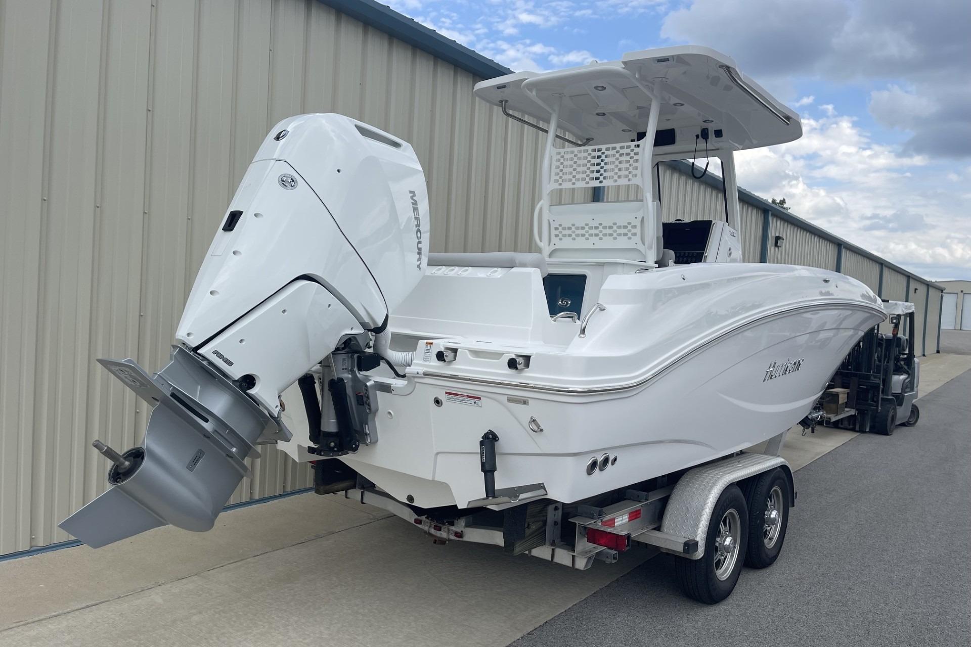 2026 Hurricane Center Console 24 OB boat on trailer, featuring a powerful Mercury outboard motor.