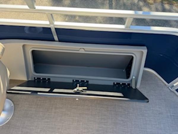 2025 Sun Tracker Fishin' Barge 22 DLX storage compartment on boat.