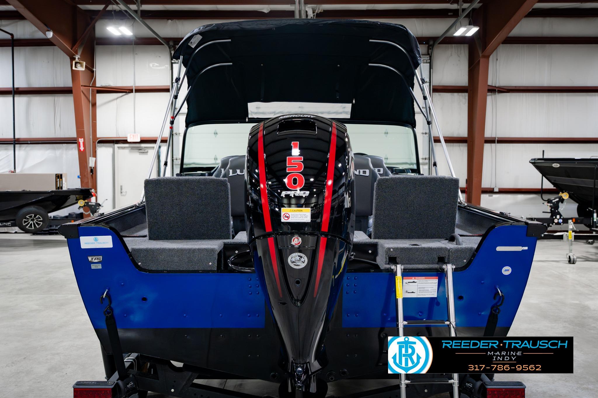 2026 Lund 1875 Impact XS boat with 150 HP engine in showroom.
