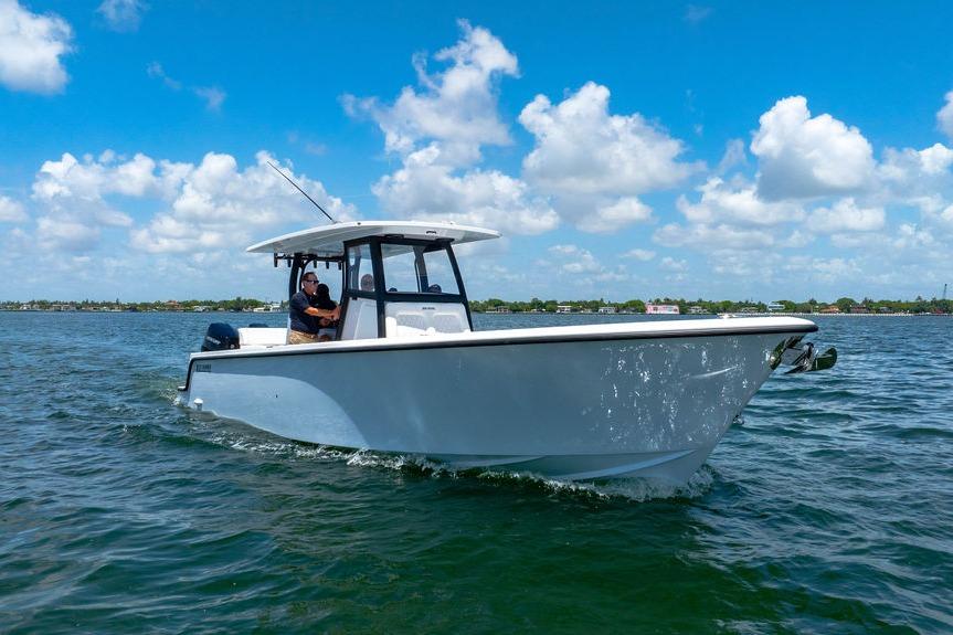 2027 Reef Runner 340 boat cruising on a sunny day with clear blue skies.