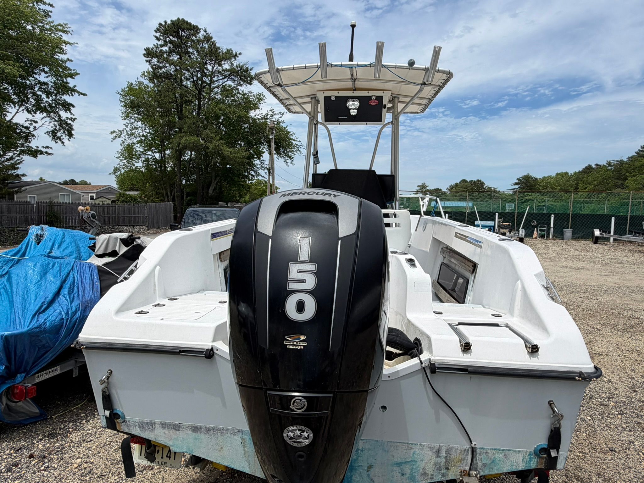 An Angler 21 boat with a 150 HP Mercury engine is on a dry dock.