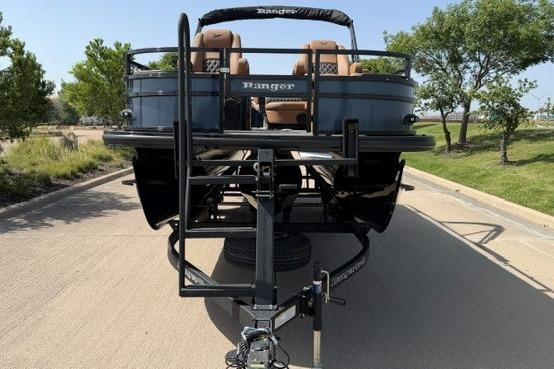 2026 Ranger 223F boat on trailer, parked on a sunny road with trees.