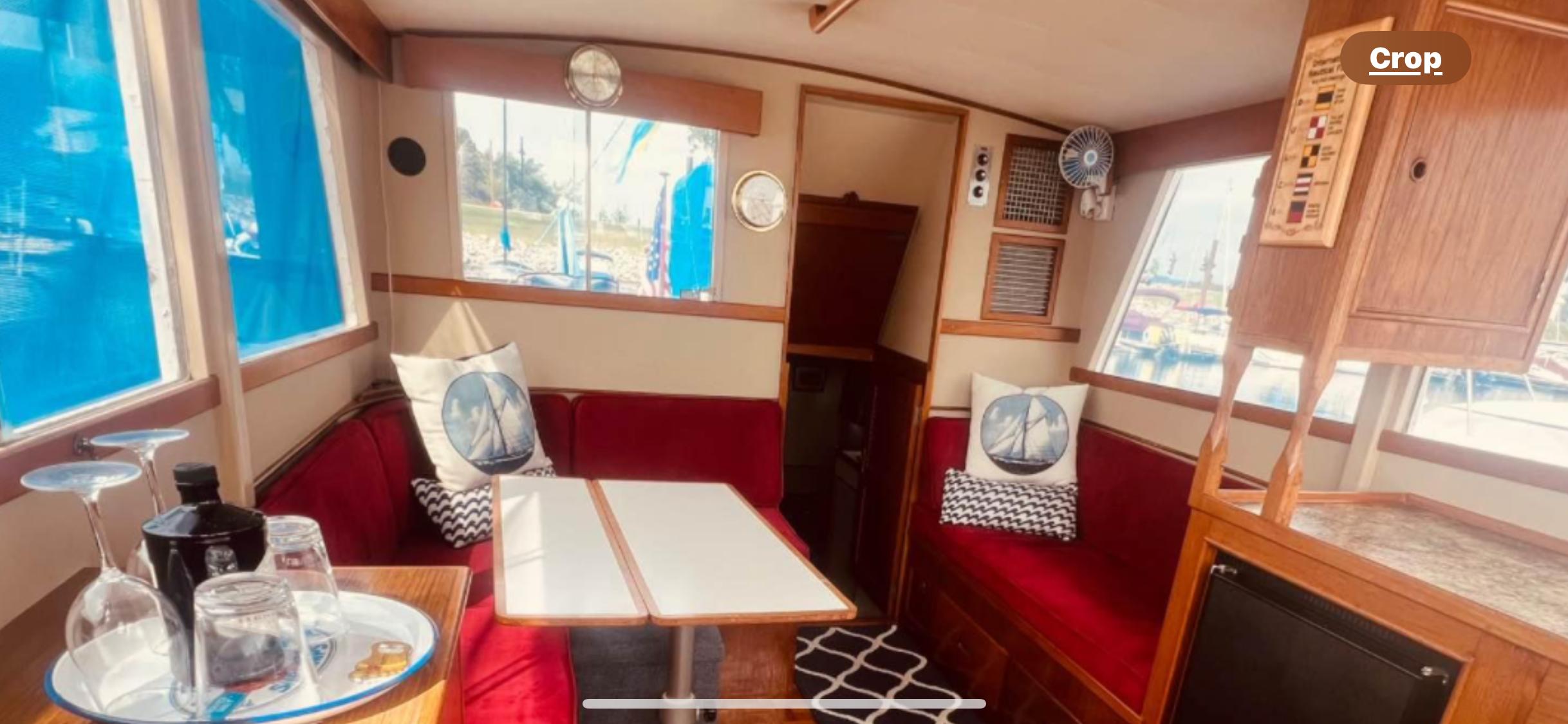 Interior of 1978 Grand Banks 36 Classic yacht with red seating and nautical decor.