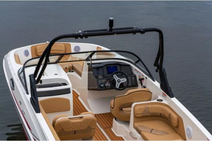 2026 Bayliner VR6 Bowrider I/O with tan seating and sleek dashboard on water.
