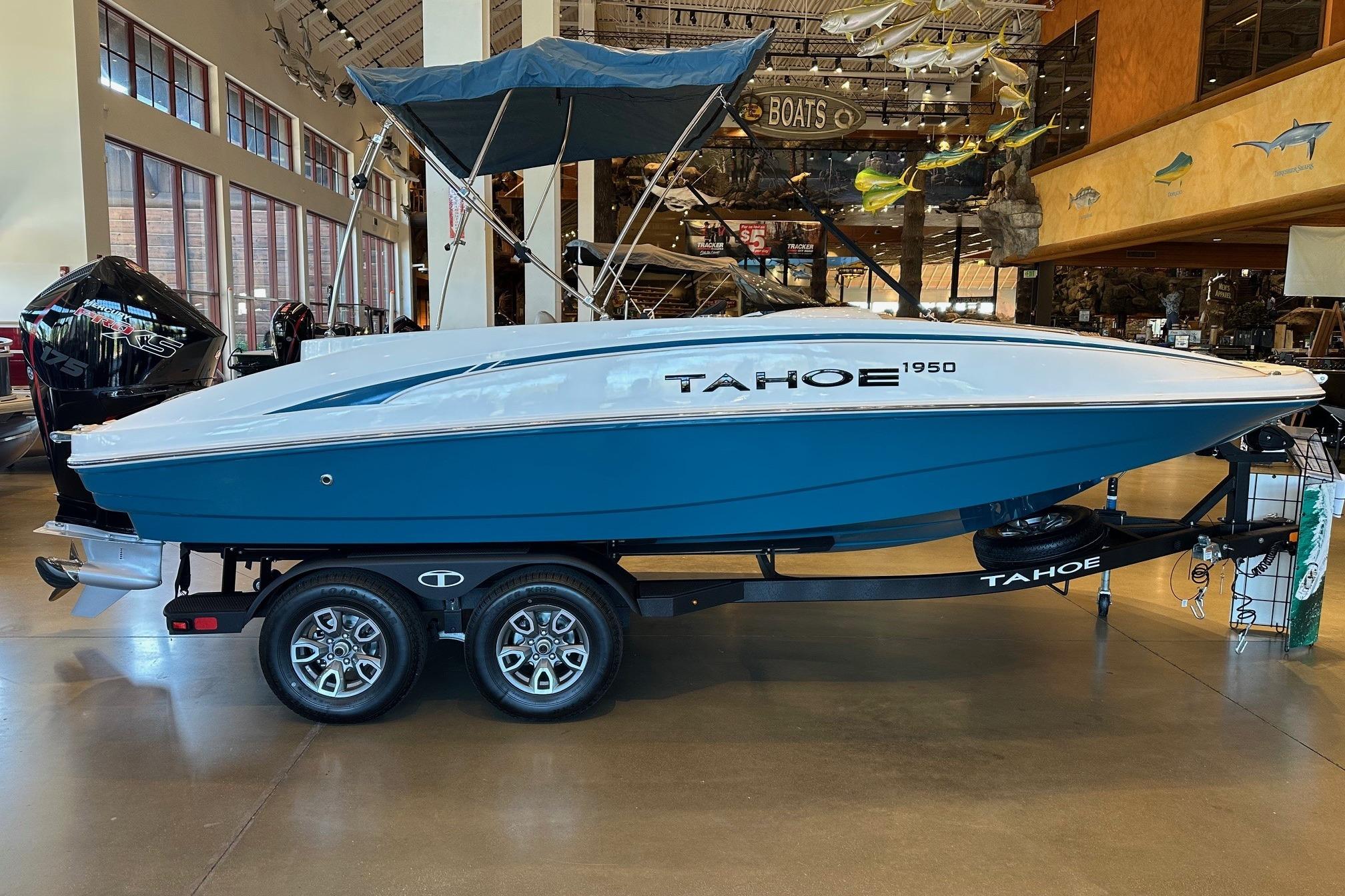 2026 Tahoe 1950 boat on display in showroom, featuring sleek design and modern features.