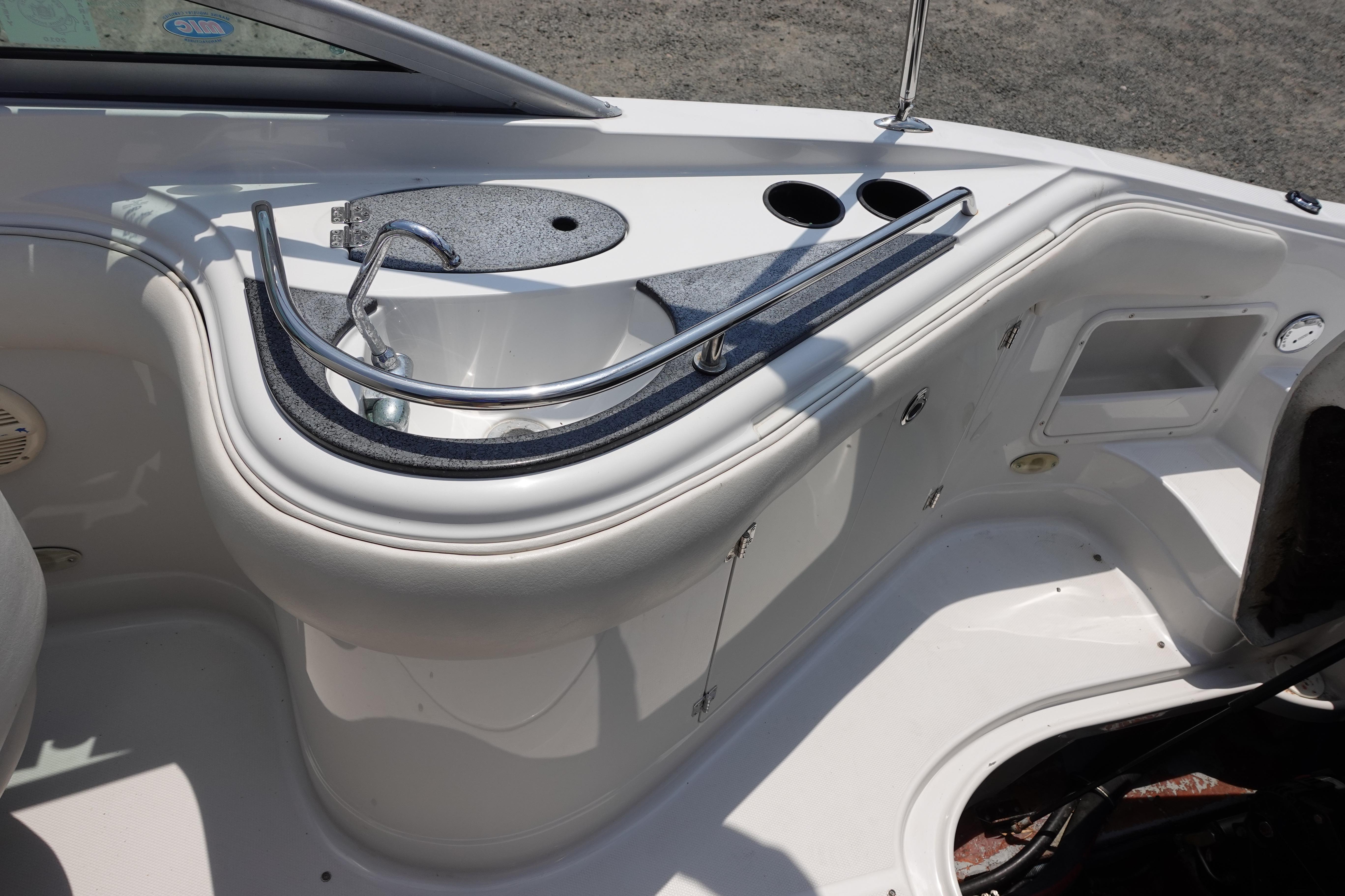 2004 Crownline 240 EX boat interior with sink and cup holders.
