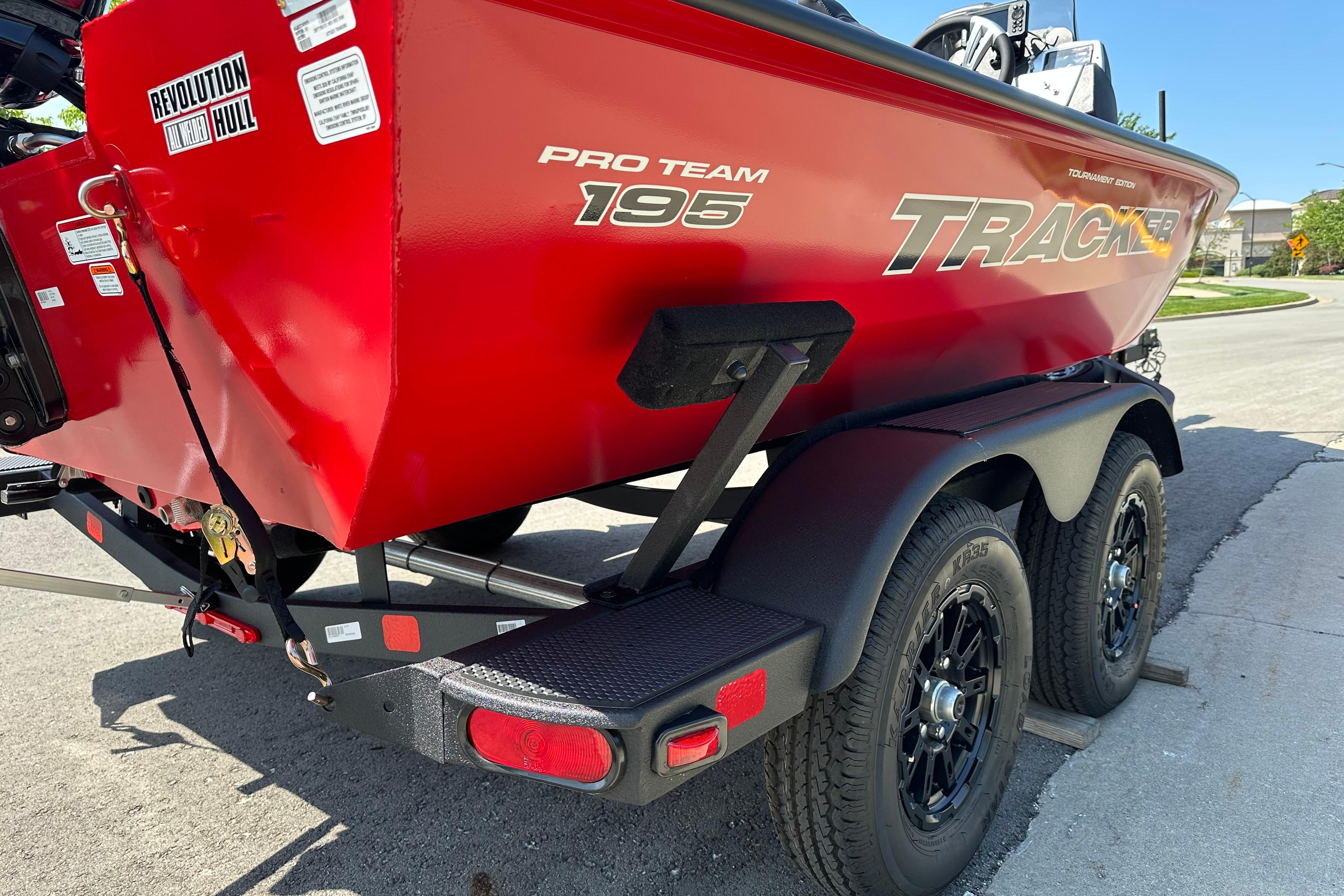 Red 2026 Tracker Pro Team 195 boat on trailer, featuring Revolution Hull design.